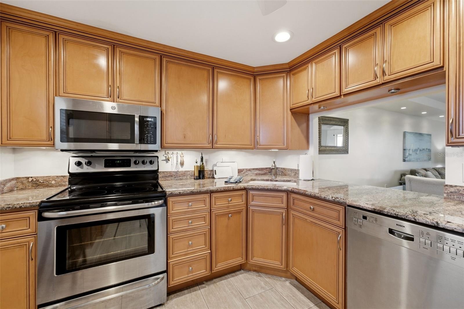 Bright kitchen featuring stainless-steel appliances and abundant cabinetry.
