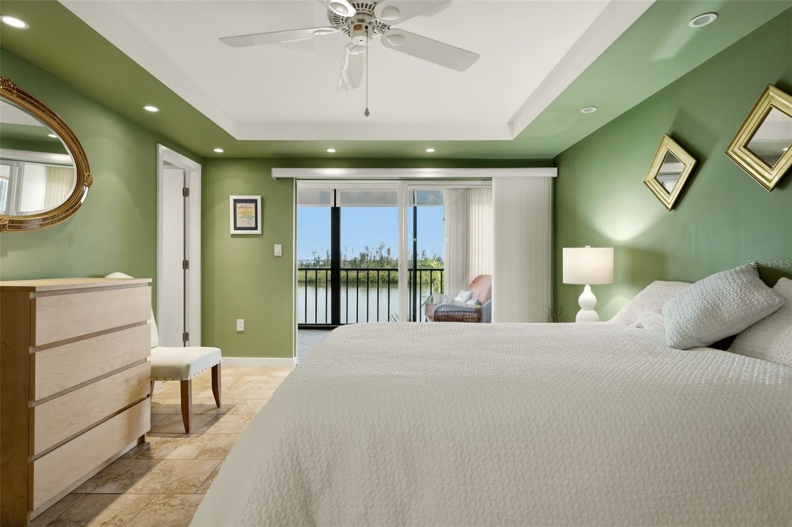Spacious primary bedroom with coastal views and natural light
