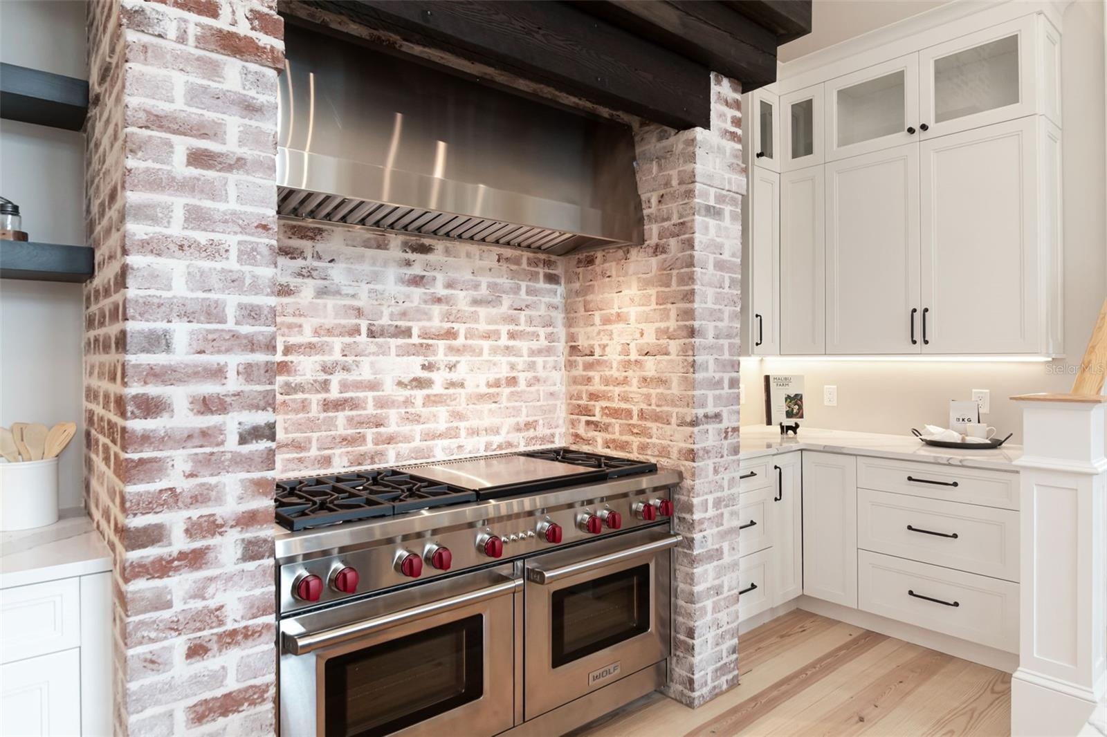 Double Wolf ovens with 6 burner cooktop and griddle