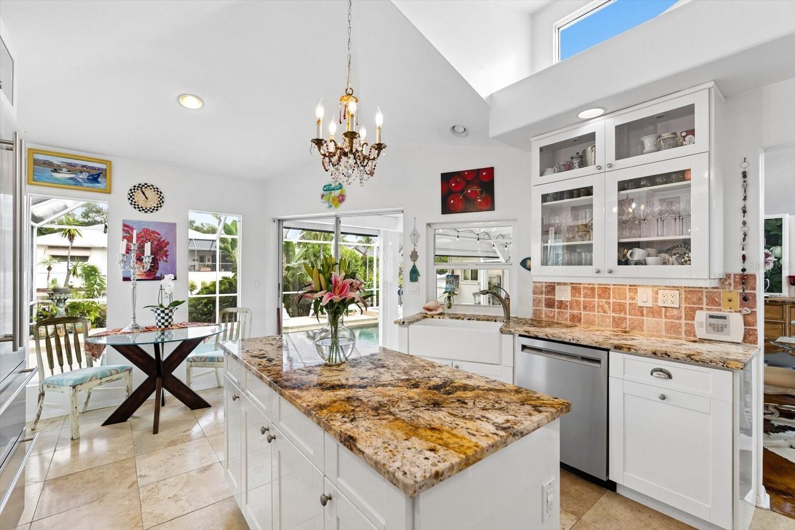 Kitchen w/ views of the pool and canal.