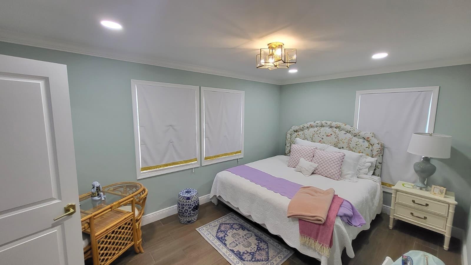 Recessed lighting, crown molding, two windows with blinds, wood-finish flooring, and a decorative ceiling fixture