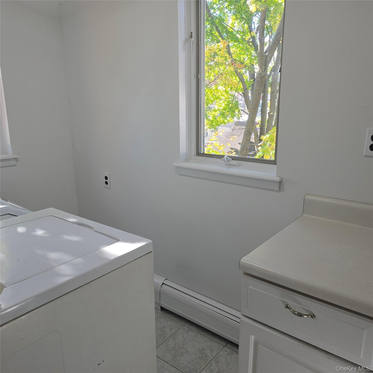 Washroom with a baseboard heating unit