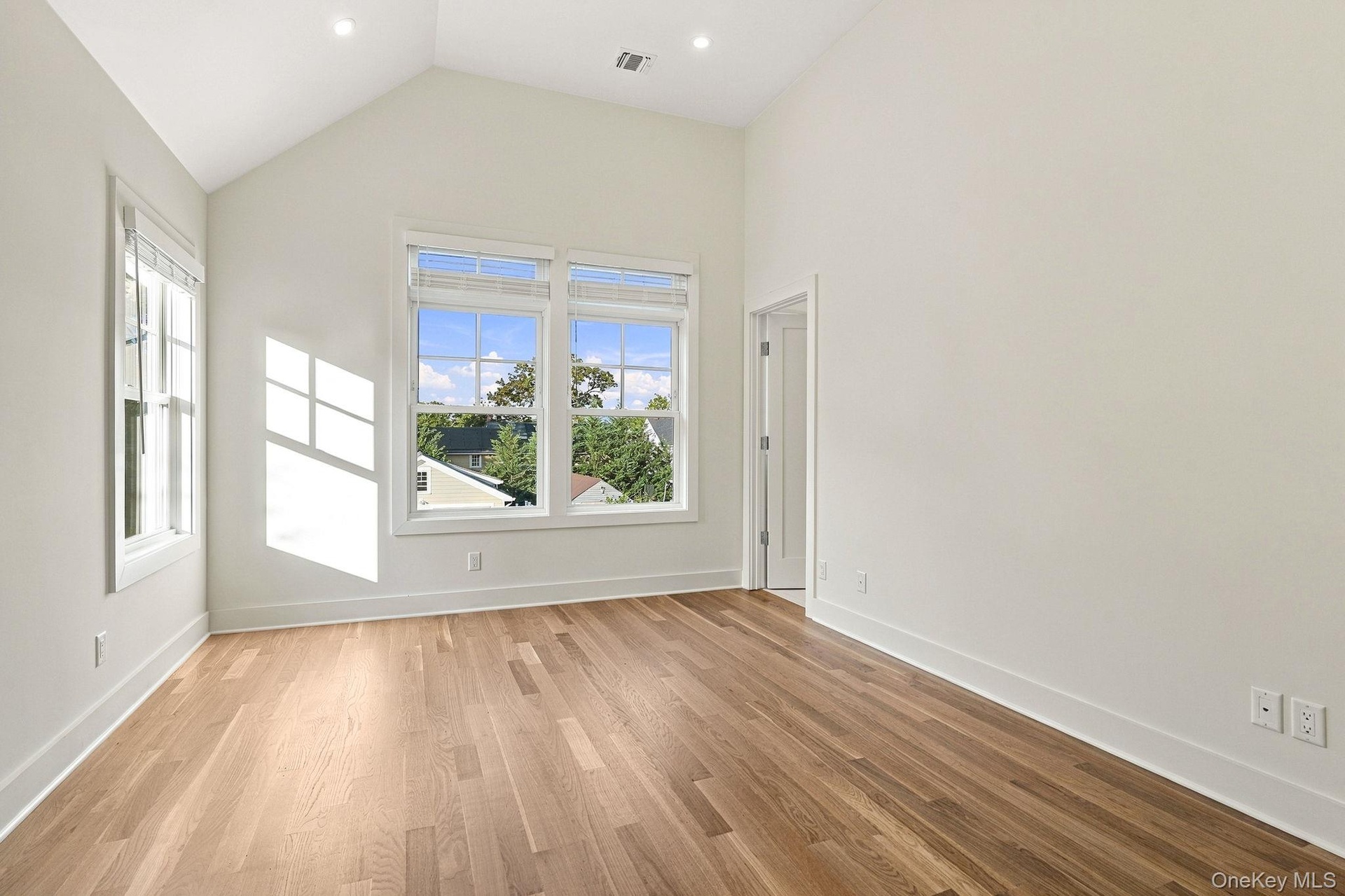 primary bedroom with cathedral ceilings