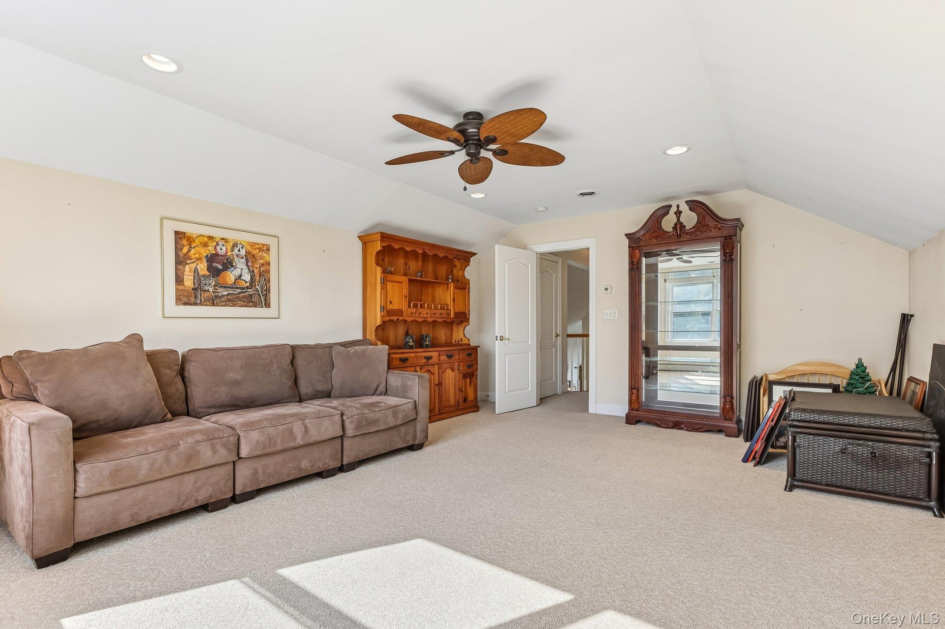 Recessed lighting, sloped ceiling, ceiling fan, neutral wall paint, and carpeted flooring
