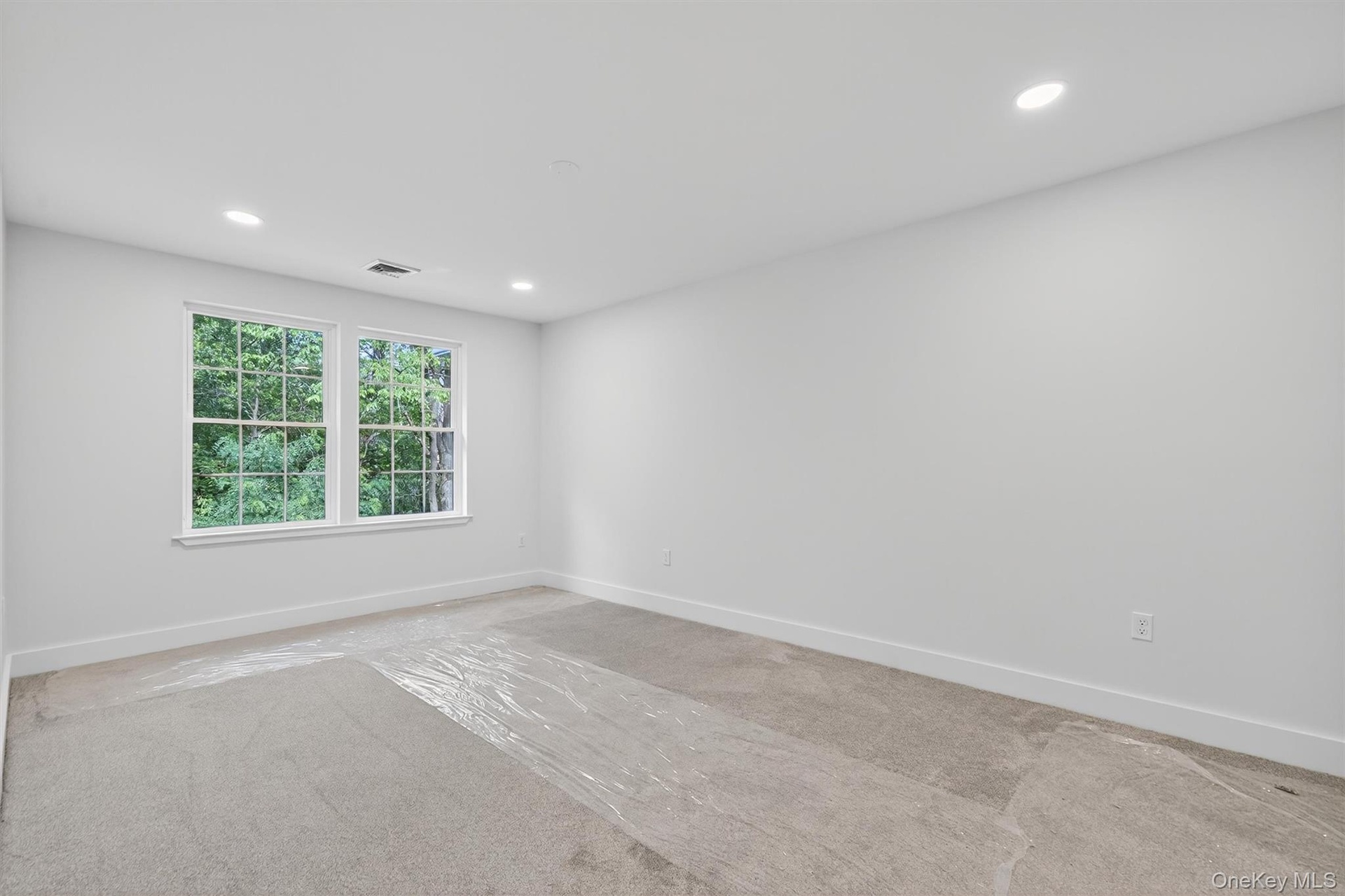 Spare room with recessed lighting and carpet floors