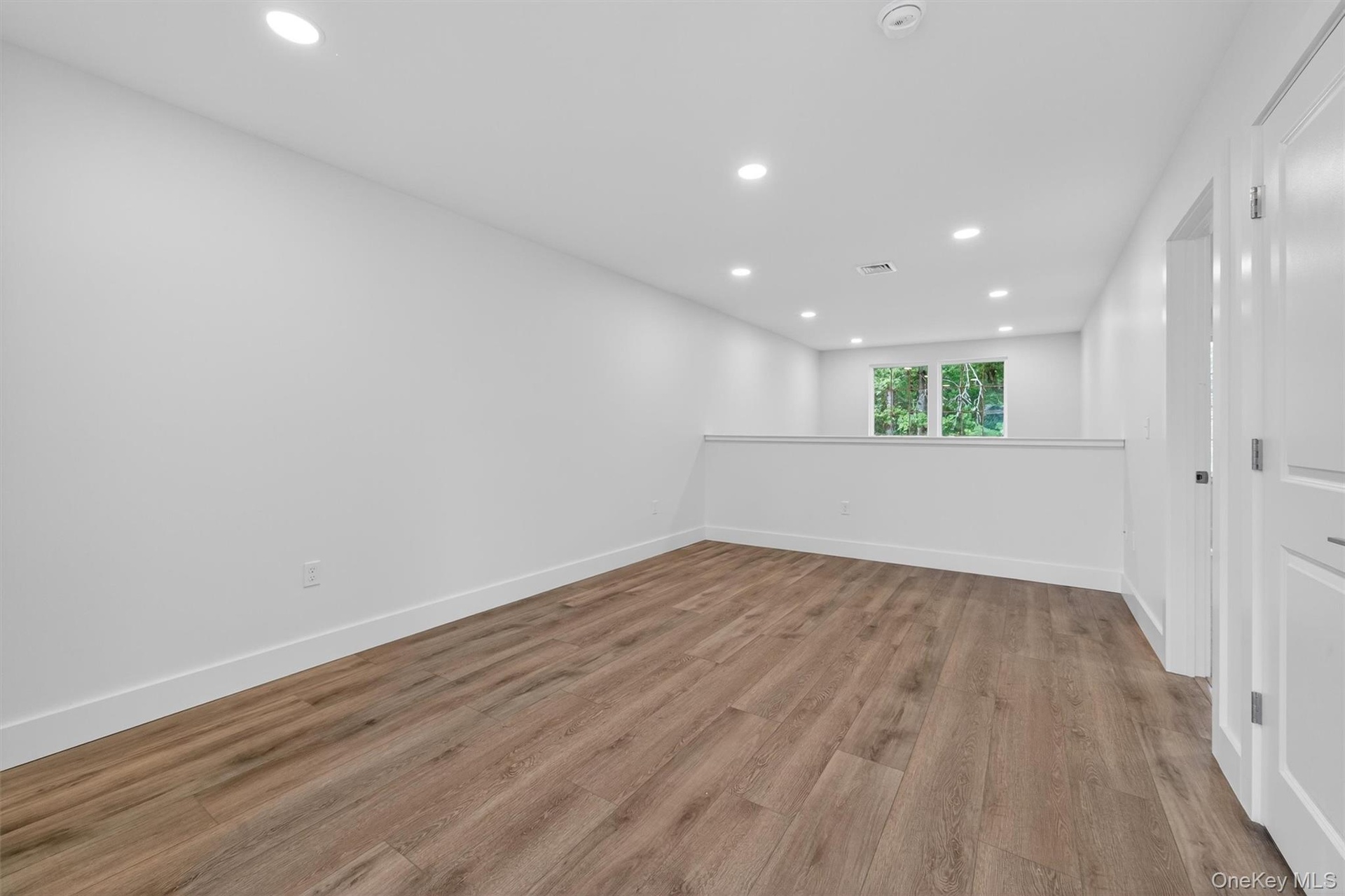 Spare room with recessed lighting and light wood-type flooring