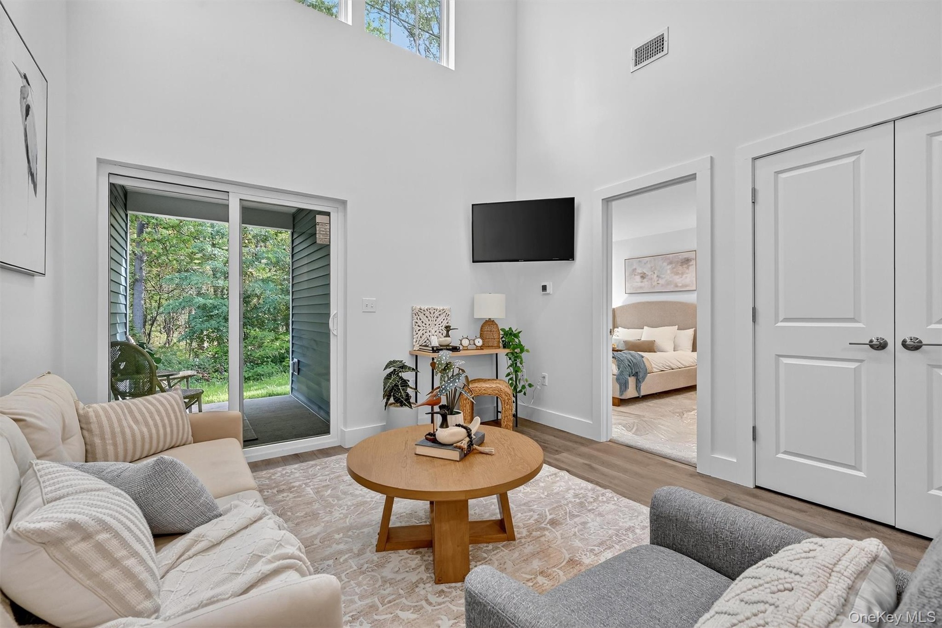 Living room with a towering ceiling and wood finished floors
