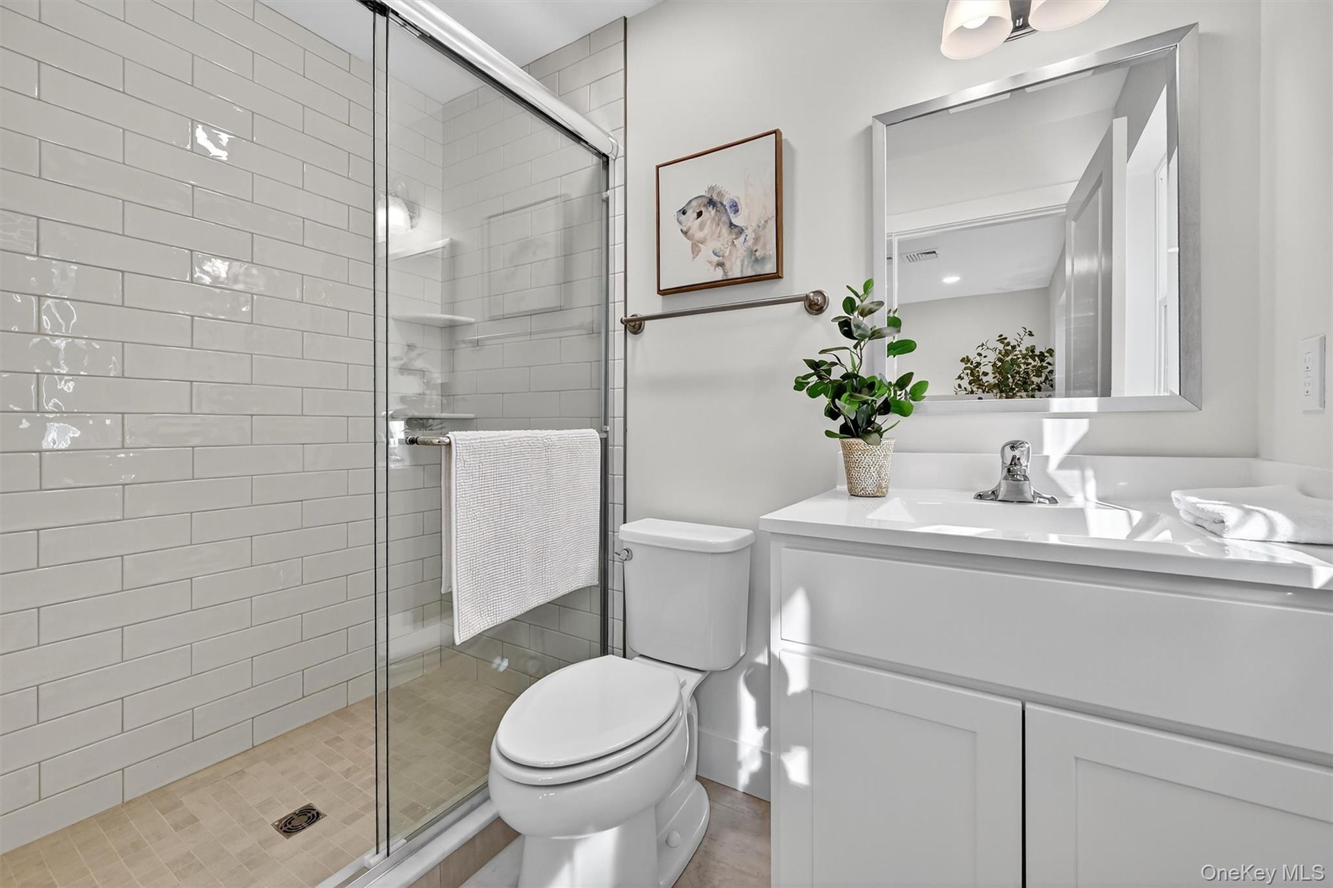 Bathroom featuring a stall shower and vanity