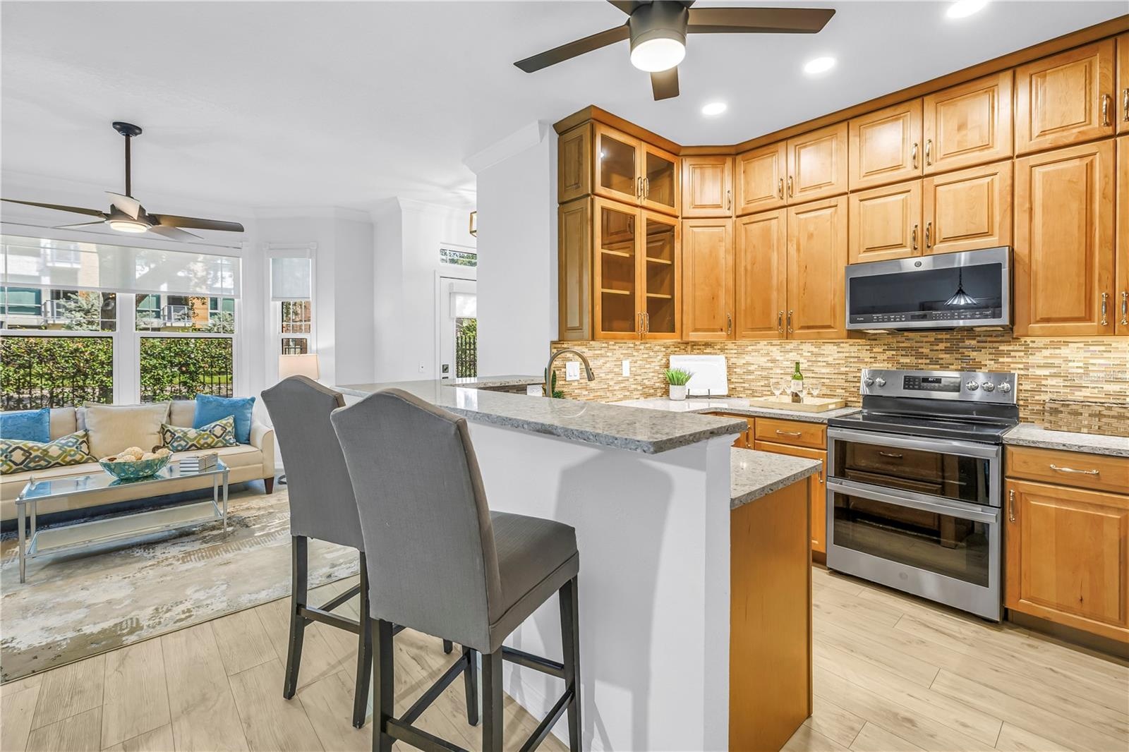 Another view of the renovated kitchen shows its generous cabinetry and easy connection to the front entry and main living areas.
