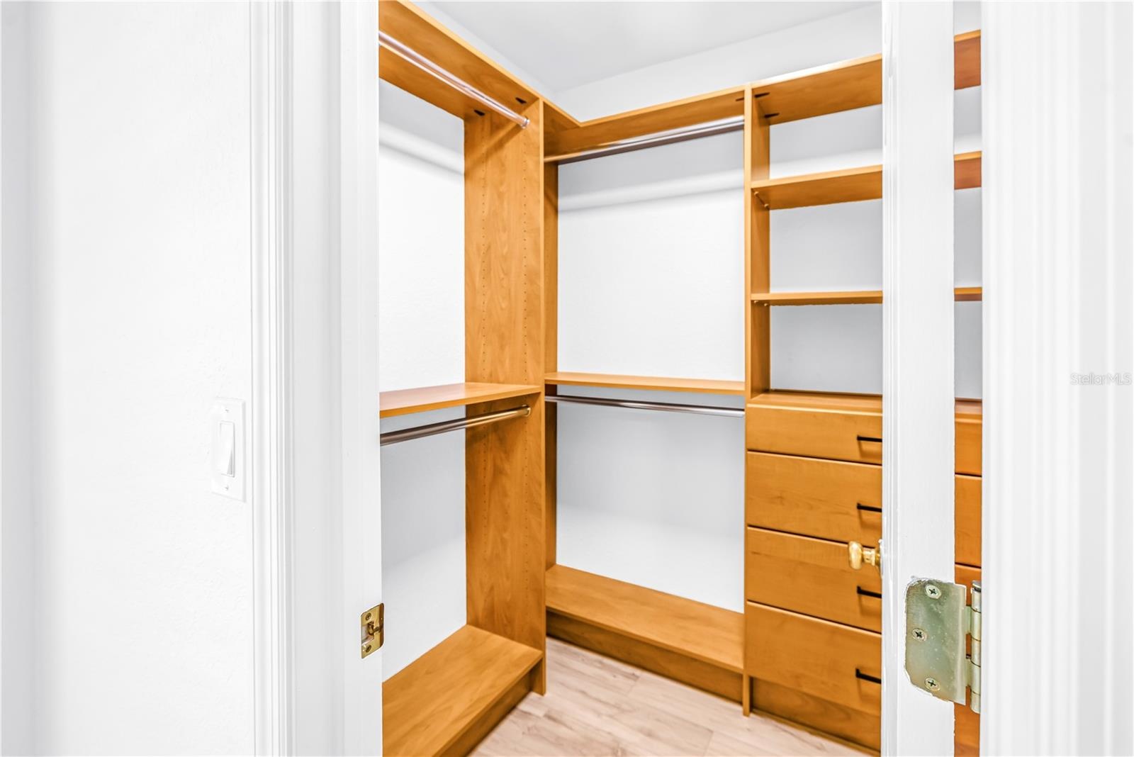 Primary Bedroom walk-in closet with California Closet