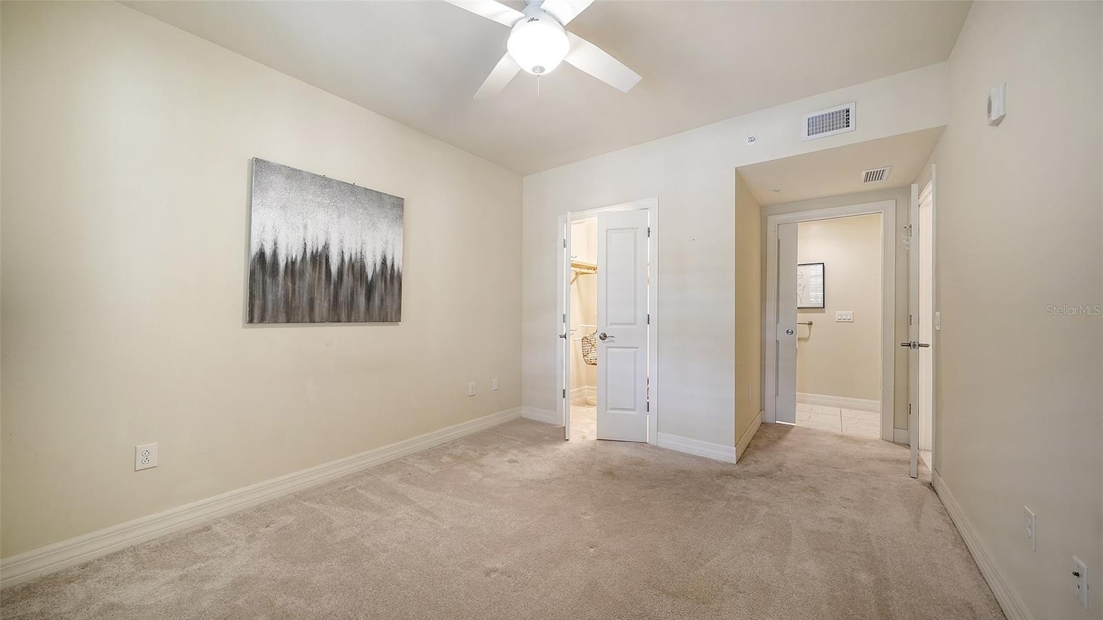 Walk-in closet with the door to the 2nd bathroom