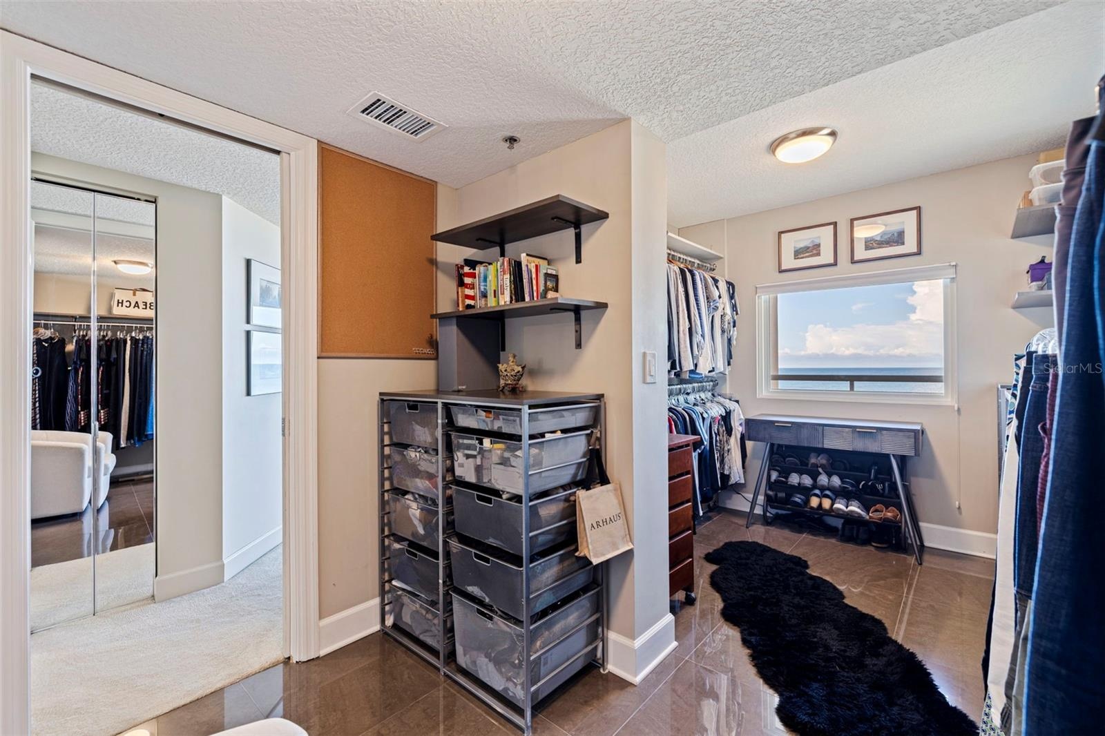 Custom designed primary walk-in closet  with view of the Gulf