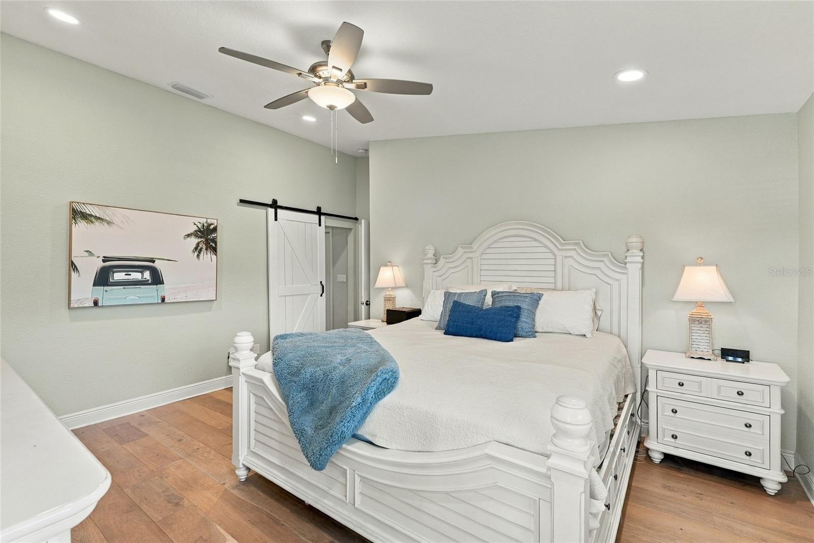 Spacious primary retreat with beautiful hardwood floors, abundant natural light, and a peaceful atmosphere.