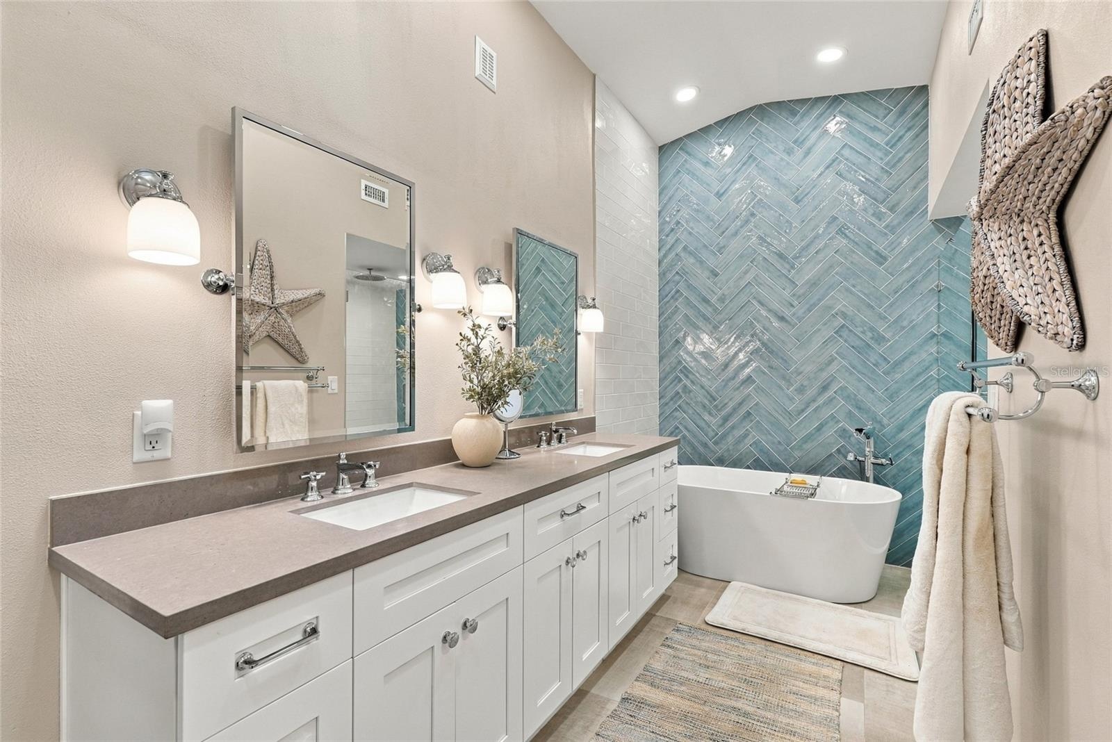 Beautifully updated primary bath featuring a freestanding soaking tub and elegant modern finishes.
