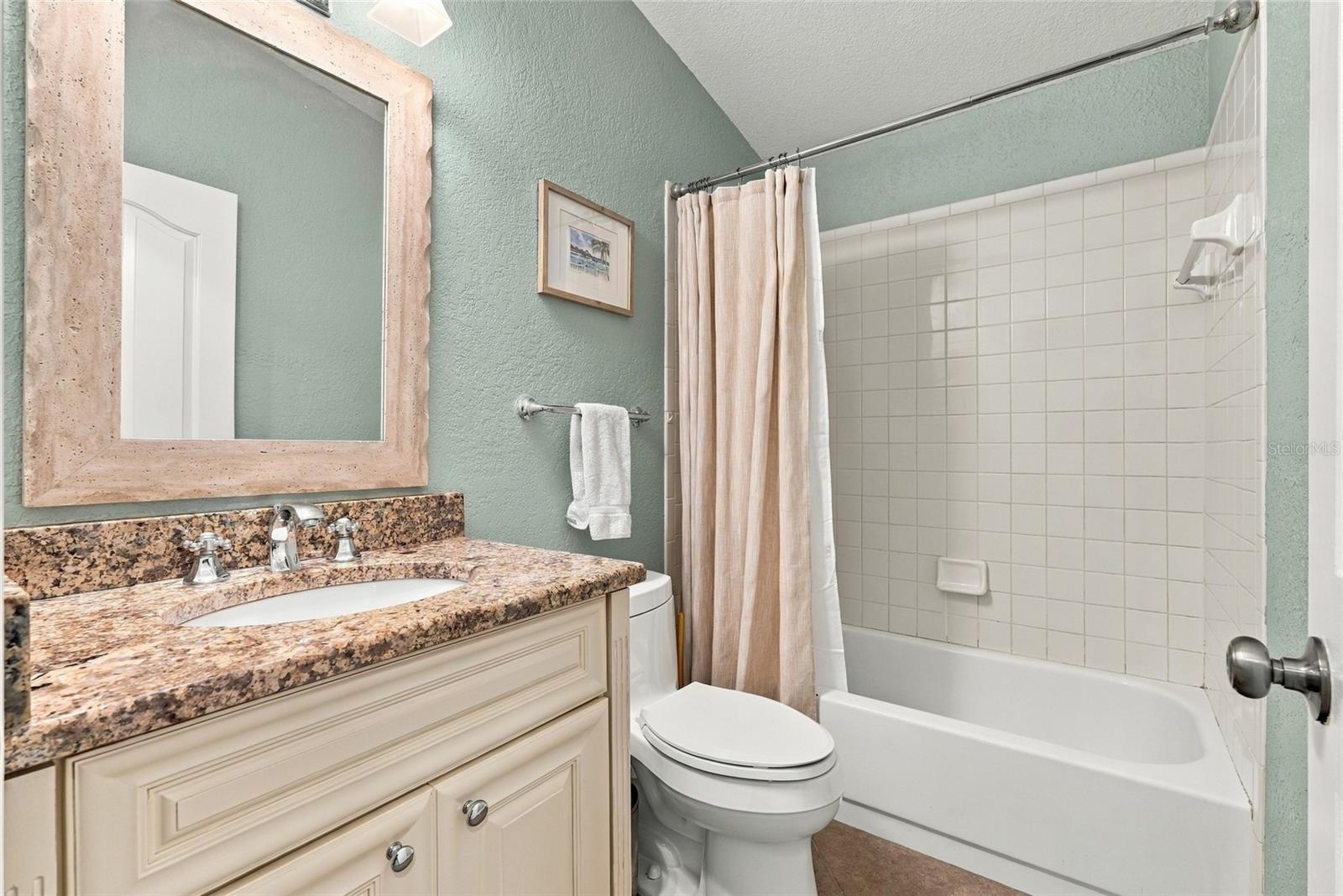 updated upstairs guest full bathroom with shower tub combo.
