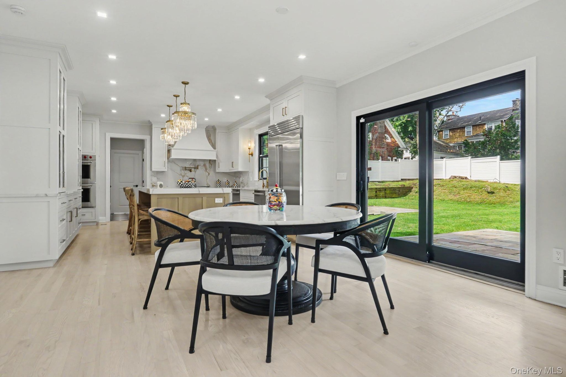 Eat-in-kitchen with sliding glass doors to backyard, Redone floors. And new black Anderson Windows.