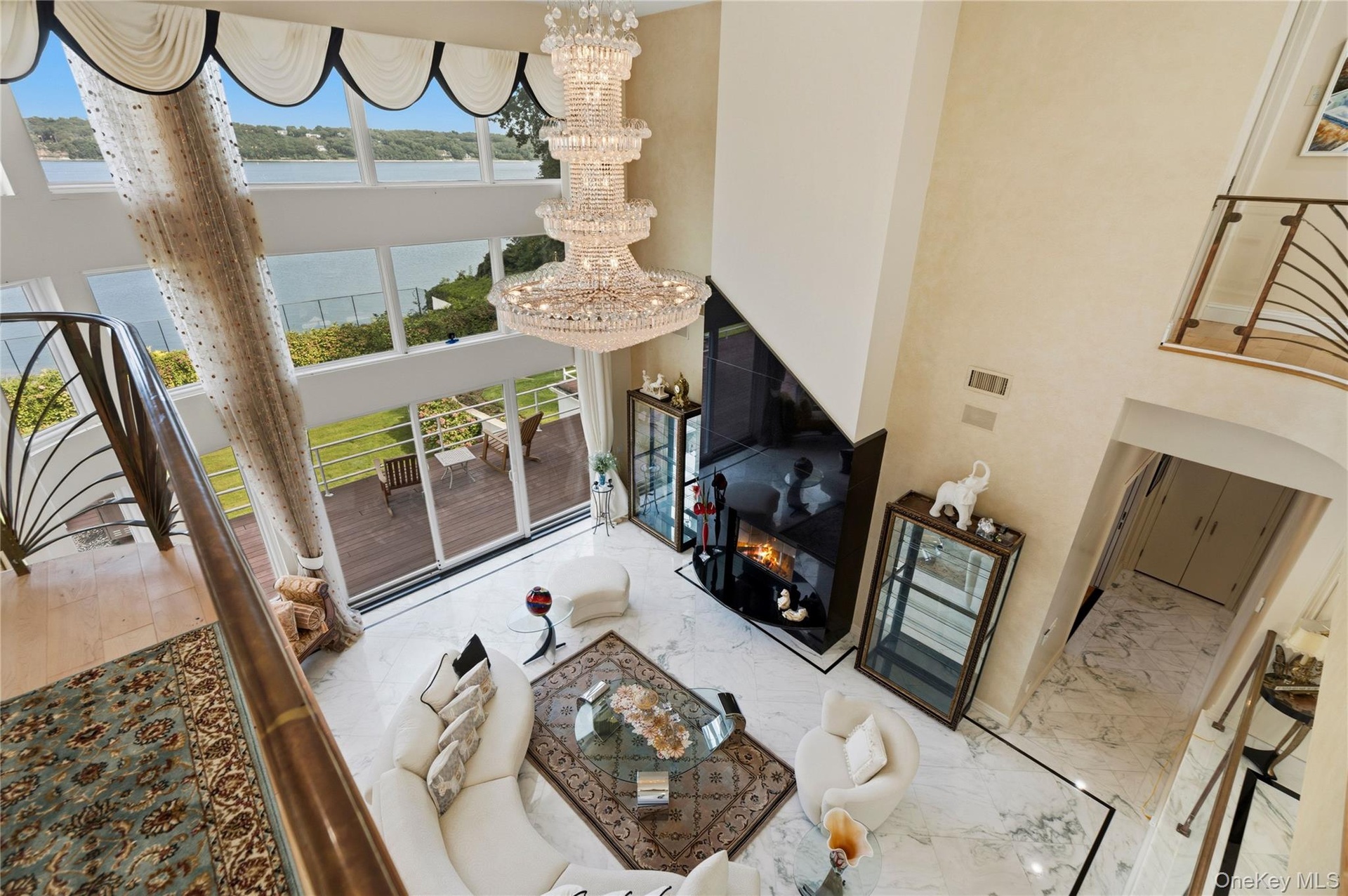 Soaring ceilings and floor-to-ceiling windows showcasing panoramic water views