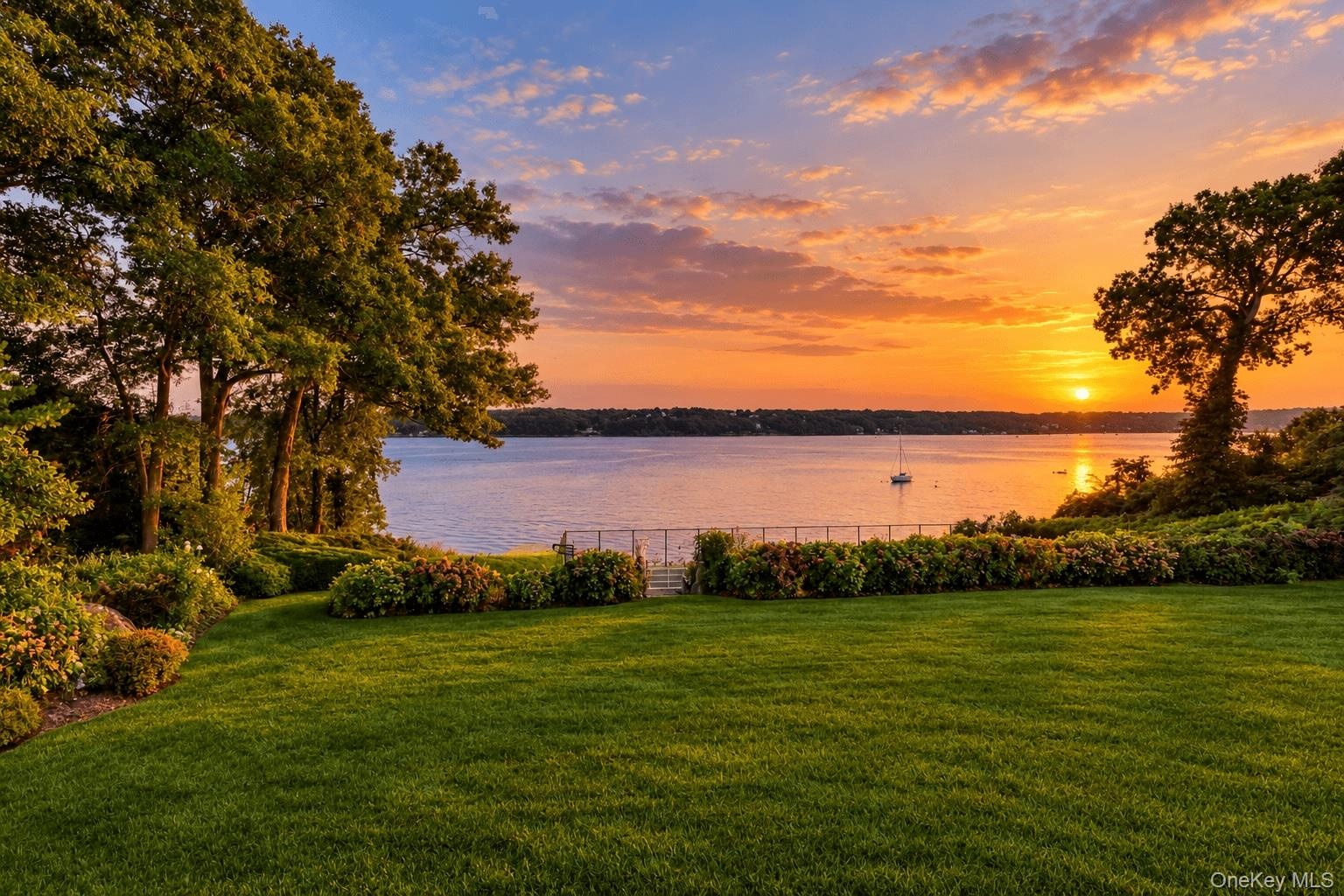 Private tennis court and gazebo overlooking the water