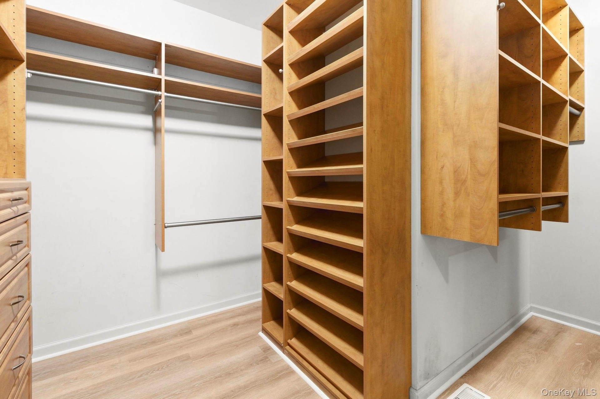 Large walk- in with custom built ins.  Plenty of drawers, hanging and shelves