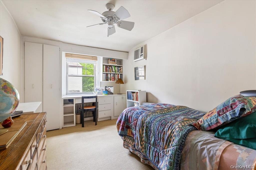 Bedroom featuring light carpet and ceiling fan