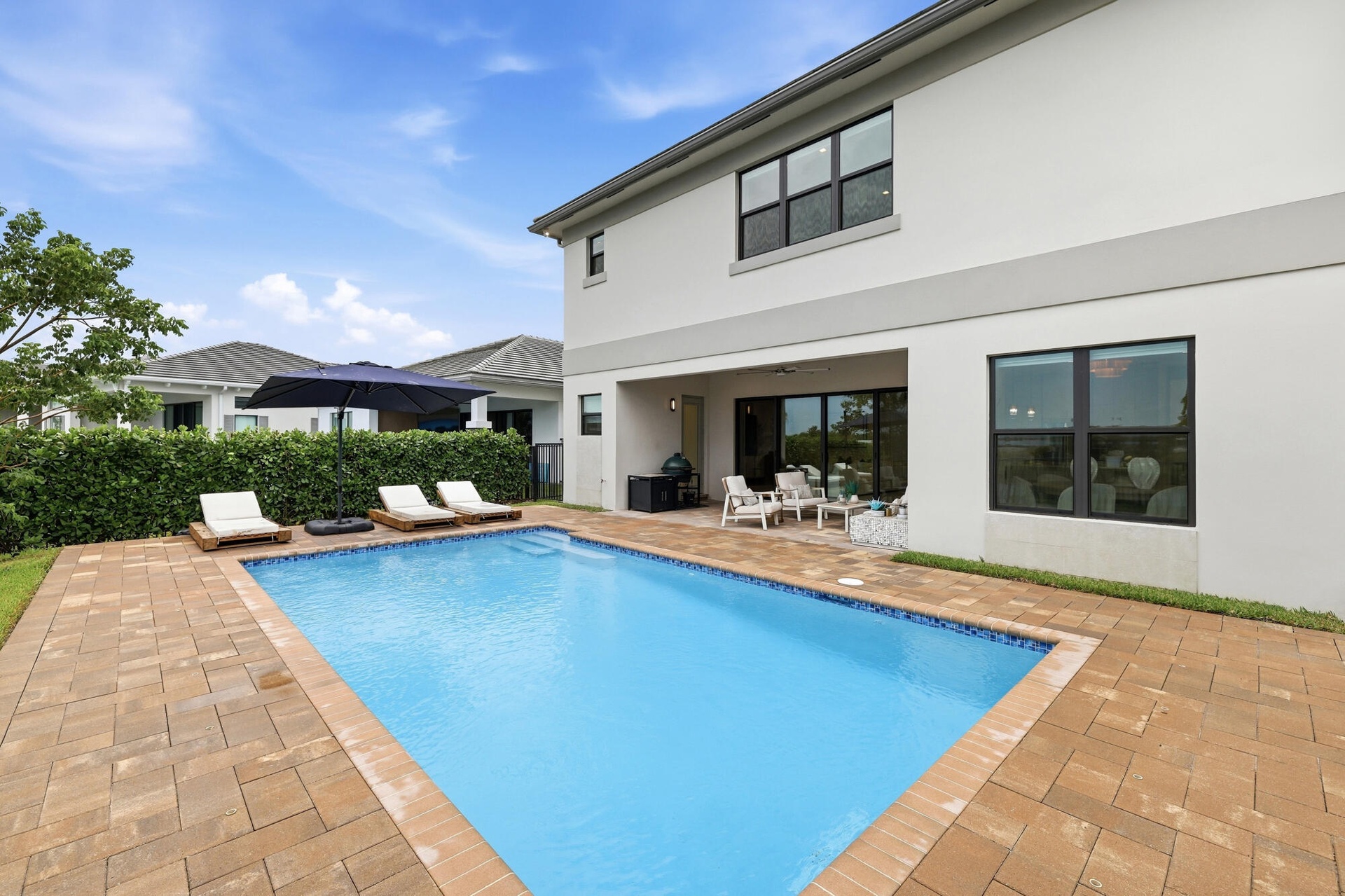 Rectangular swimming pool with a paved deck