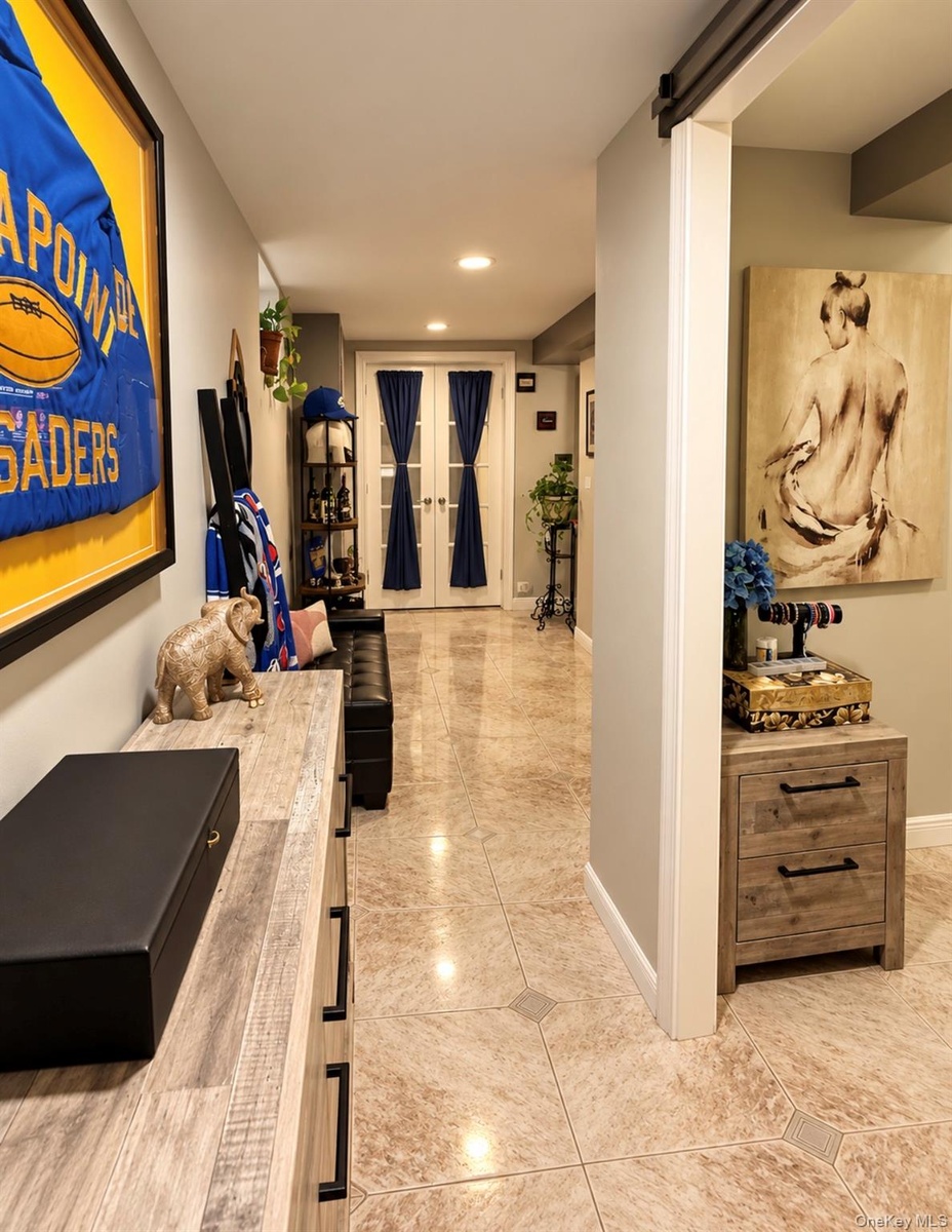 Recessed lighting, light-toned walls, and a barn door entry