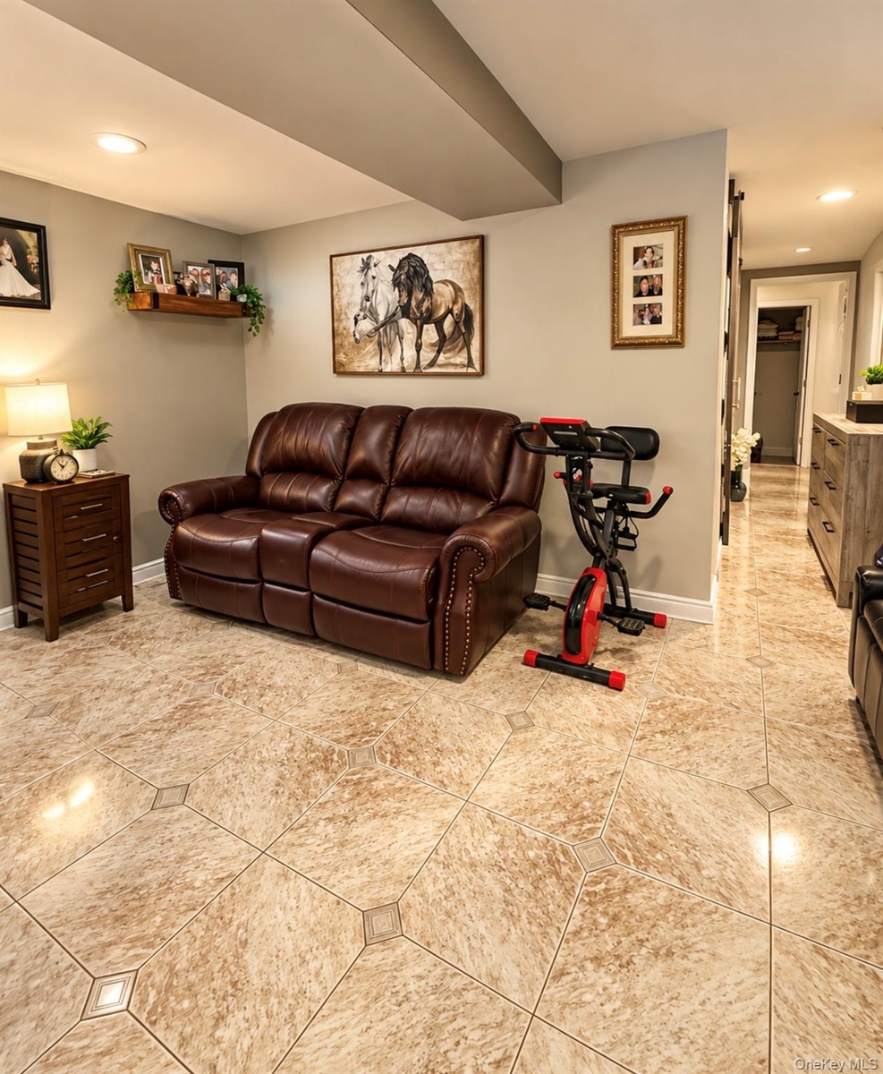 Recessed lighting, wood-finish wall shelving, and tile flooring with accent inserts