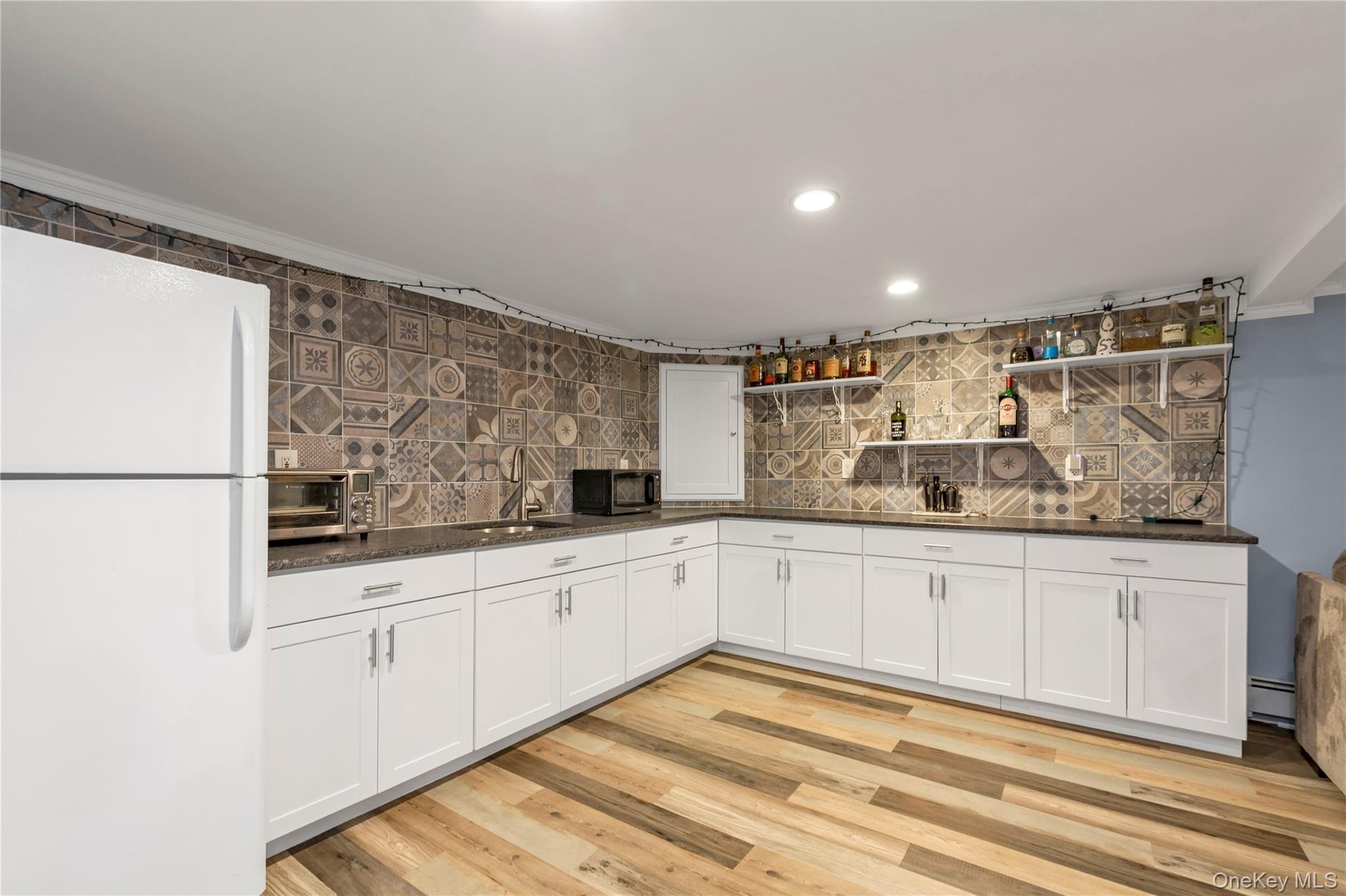 Wet Bar Area with Cabinets for Storage & Frige.