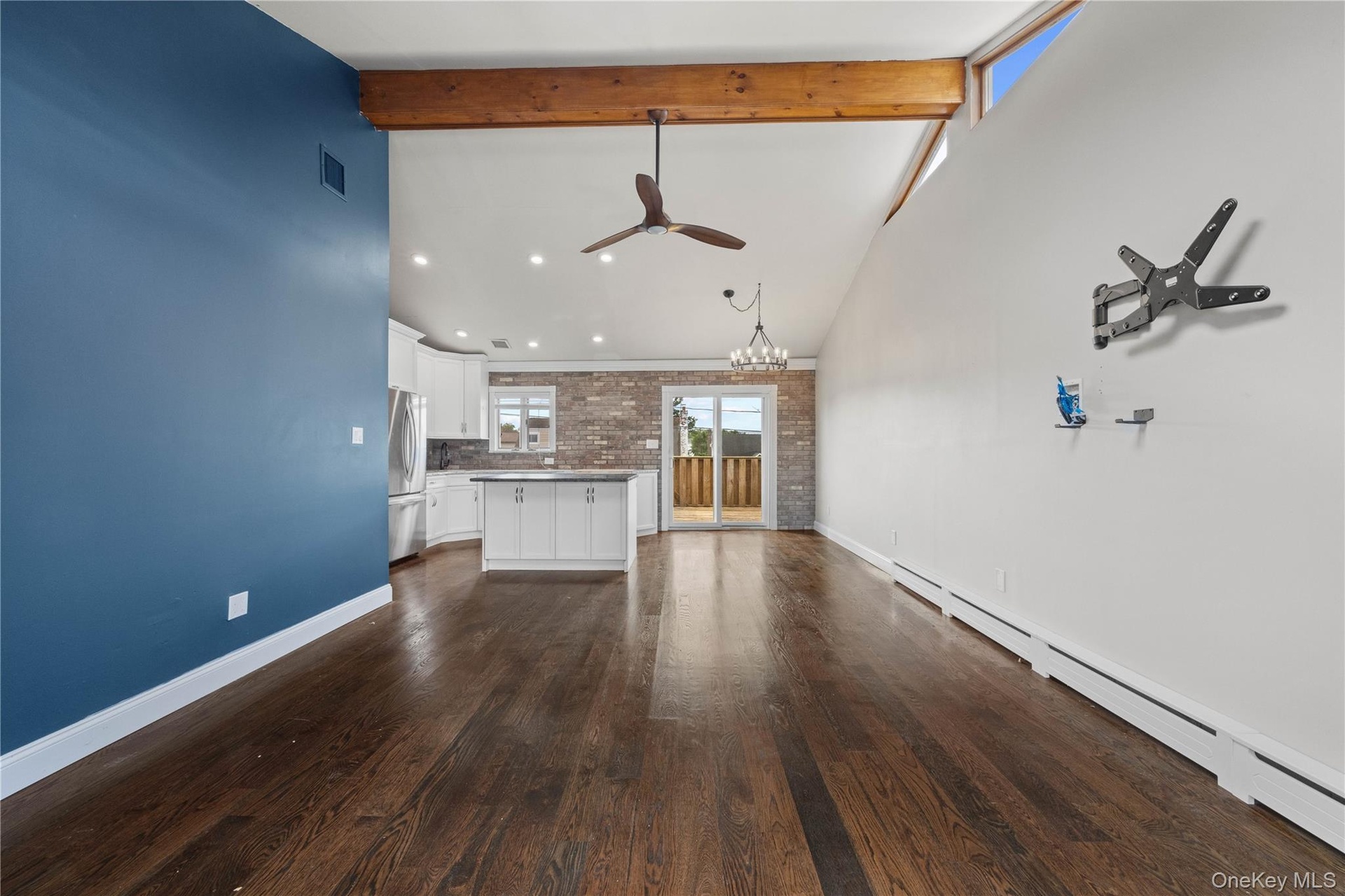 Dark wood-finish flooring with a contrasting blue accent wall