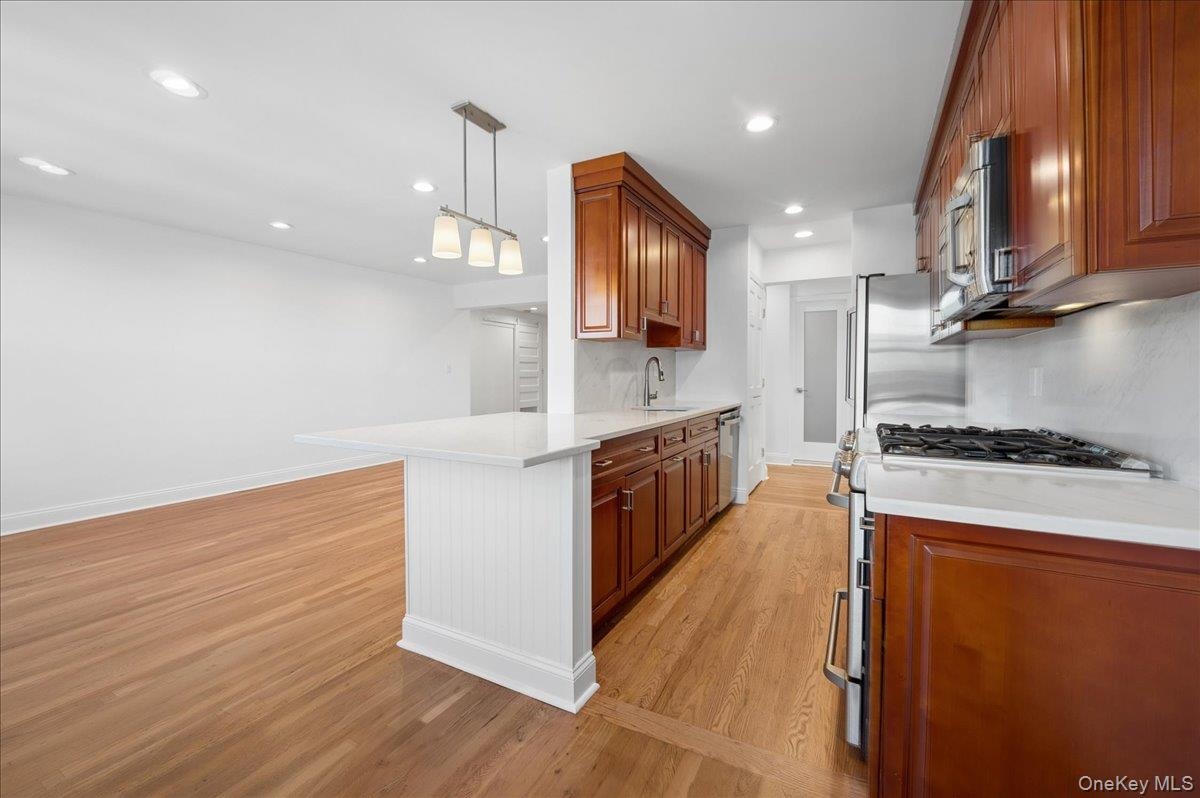 Beautifully designed kitchen also boasts a custom pantry closet.