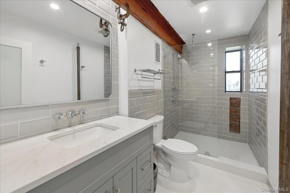 Stunning primary bathroom features original beam