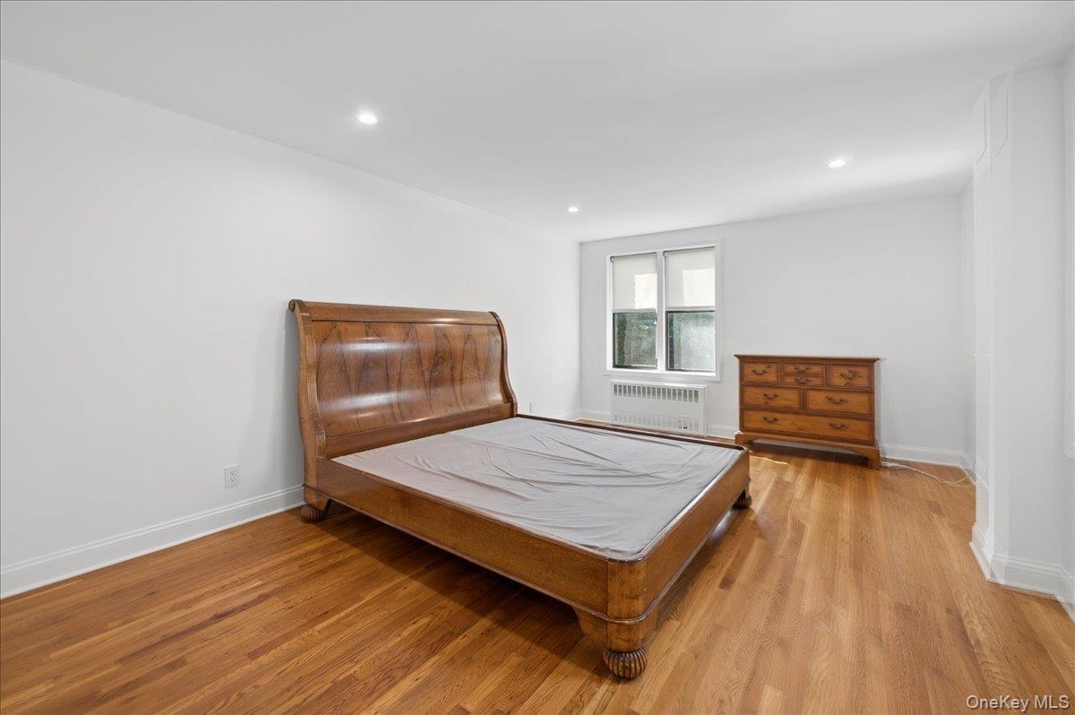 Spacious primary bedroom with recessed lighting