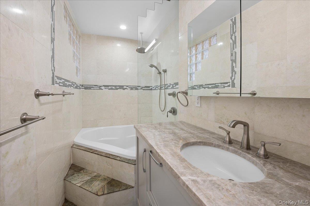 Renovated hall bath with soaking tub.