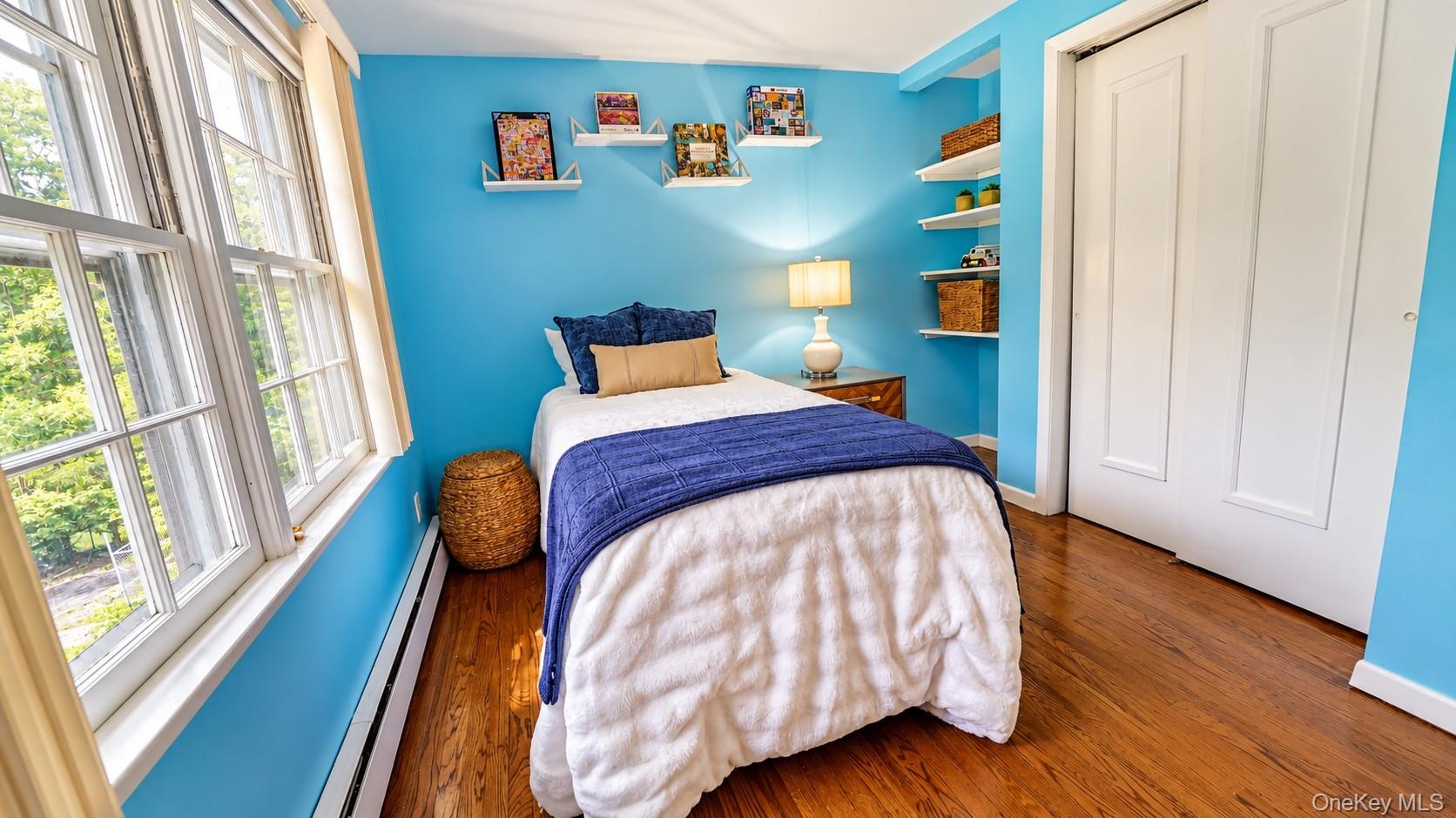 This comfortable third bedroom is enhanced by custom built-ins and a generous closet, offering both style and practical storage.