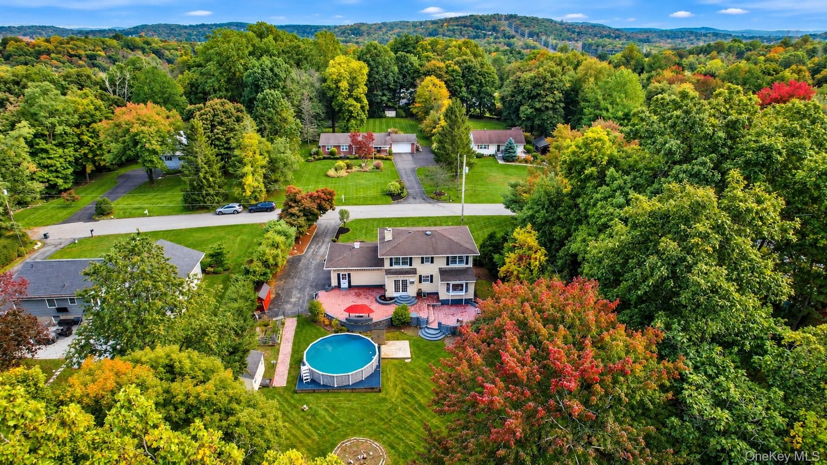 A stunning aerial view showcases this spectacular property surrounded by lush natural beauty and tucked away on a peaceful private dead-end street, of