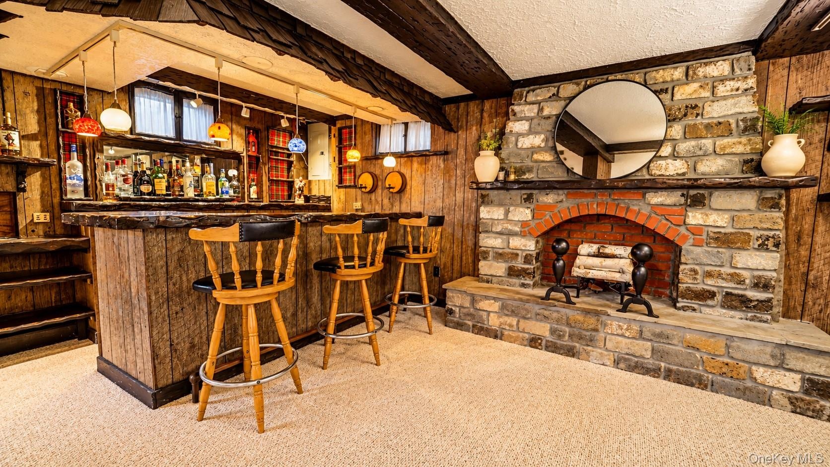 The walk-out lower level is an entertainer’s dream, featuring a gorgeous pub-style bar with custom built-ins and plenty of space to gather, unwind, la