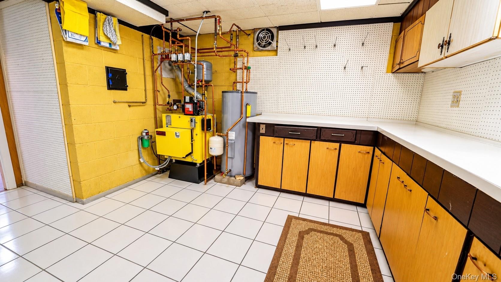 The well-maintained mechanical room features a newer oil furnace, hot water heater, and abundant storage space, offering both efficiency and practical