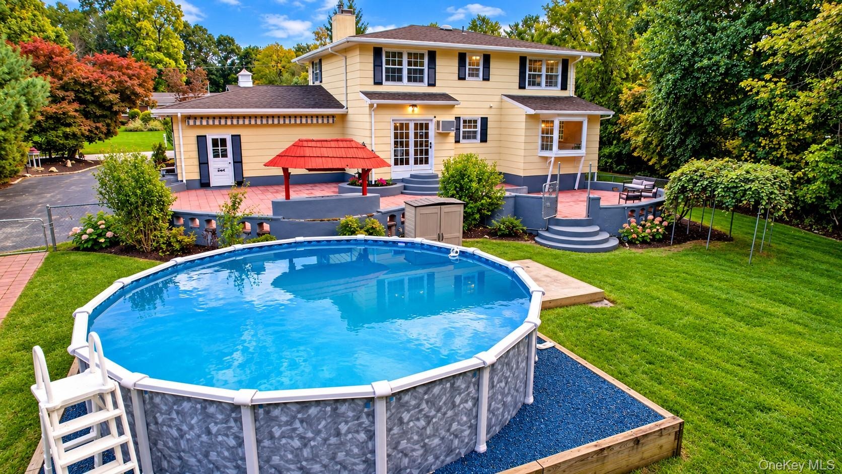 The above-ground 24x52 pool, perfectly positioned alongside the expansive patio, creates the ultimate outdoor entertainment space—ideal for summer gat