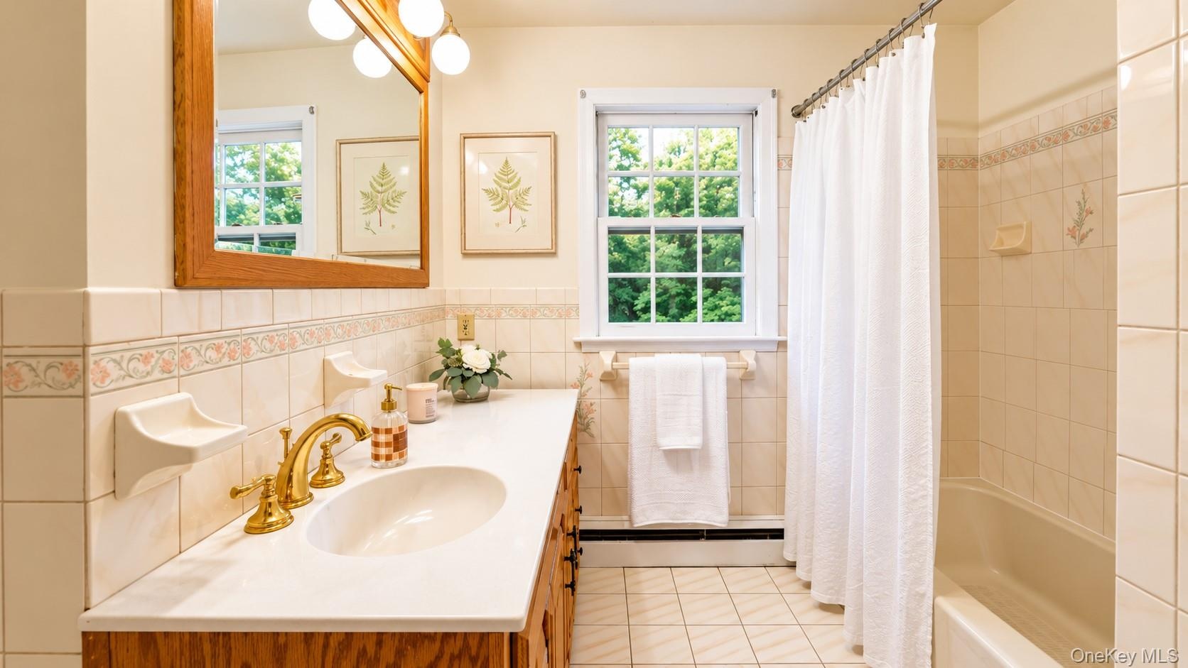 The spacious hallway full bath features a convenient tub and shower combination, offering comfort and functionality.