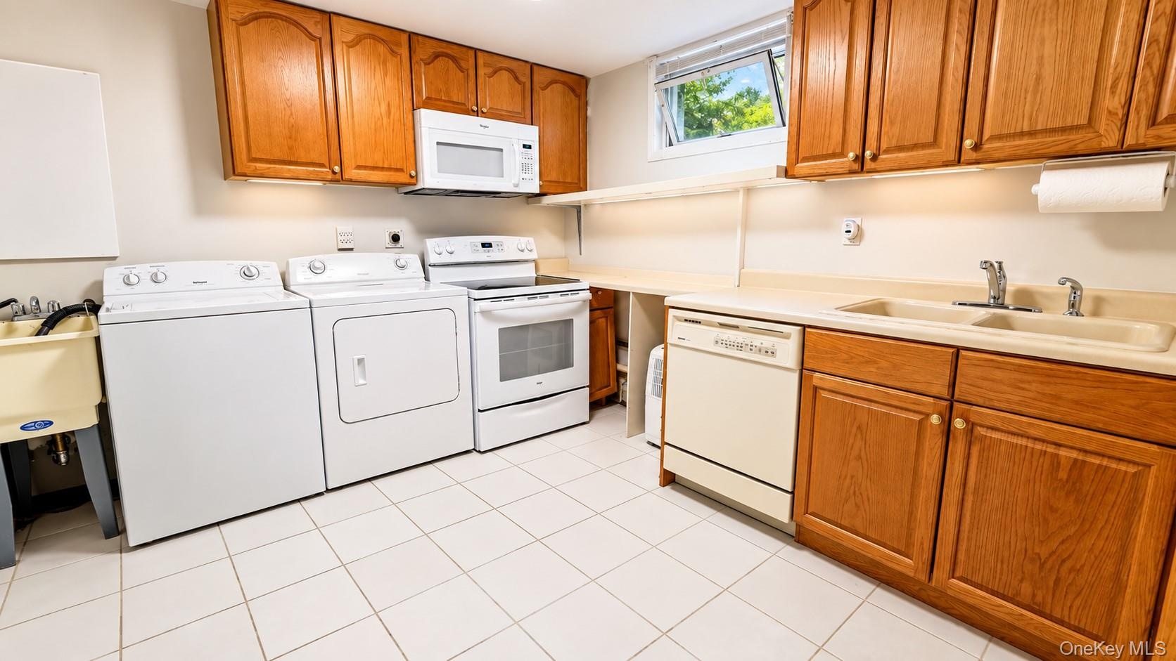 A convenient laundry room combined with a summer kitchen creates a versatile and functional space, ideal for multi-generational living, extended guest