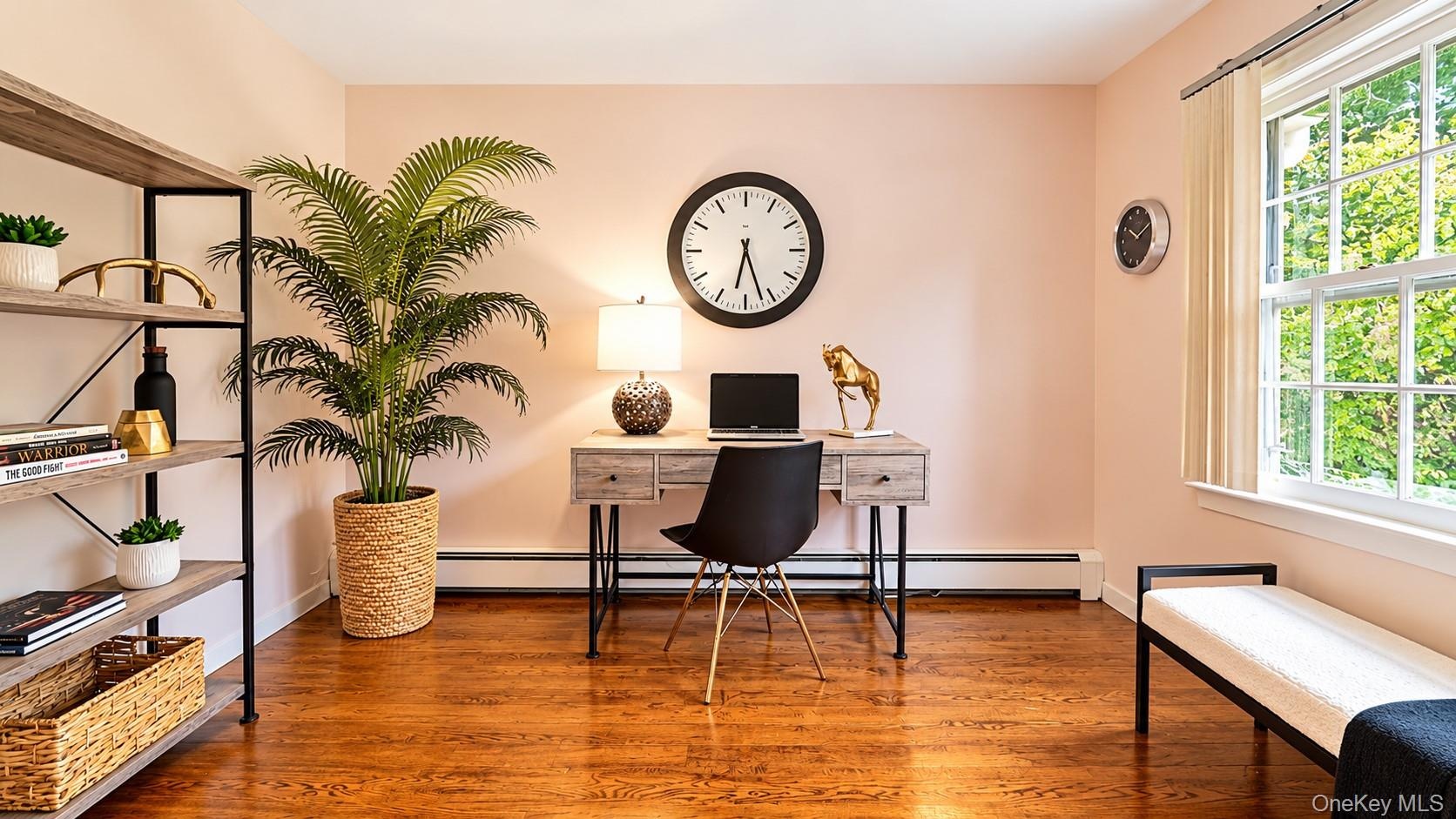 The spacious fourth bedroom offers exceptional versatility and is currently showcased as the perfect home office, providing plenty of room to work, cr