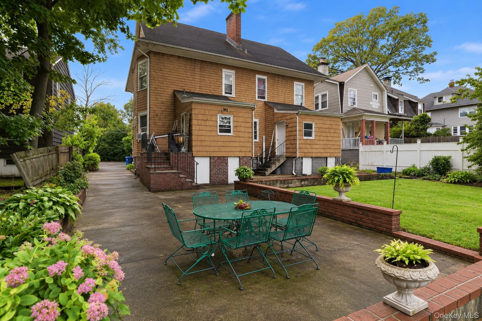 Gracious and welcoming backyard for dining, BBQing, and gardening