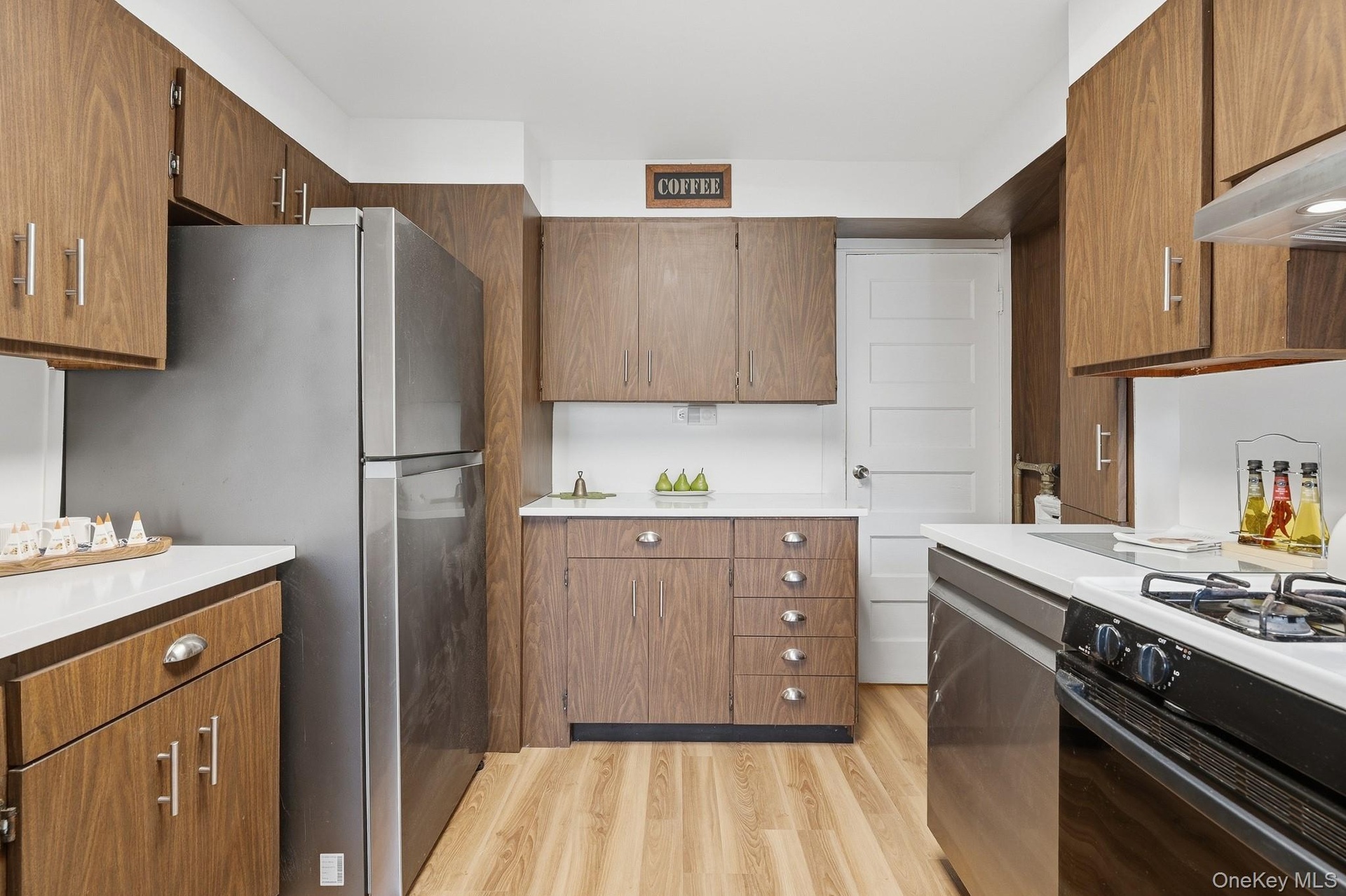 Clean bright Kitchen w/new floors, DW & tons of cabinetry