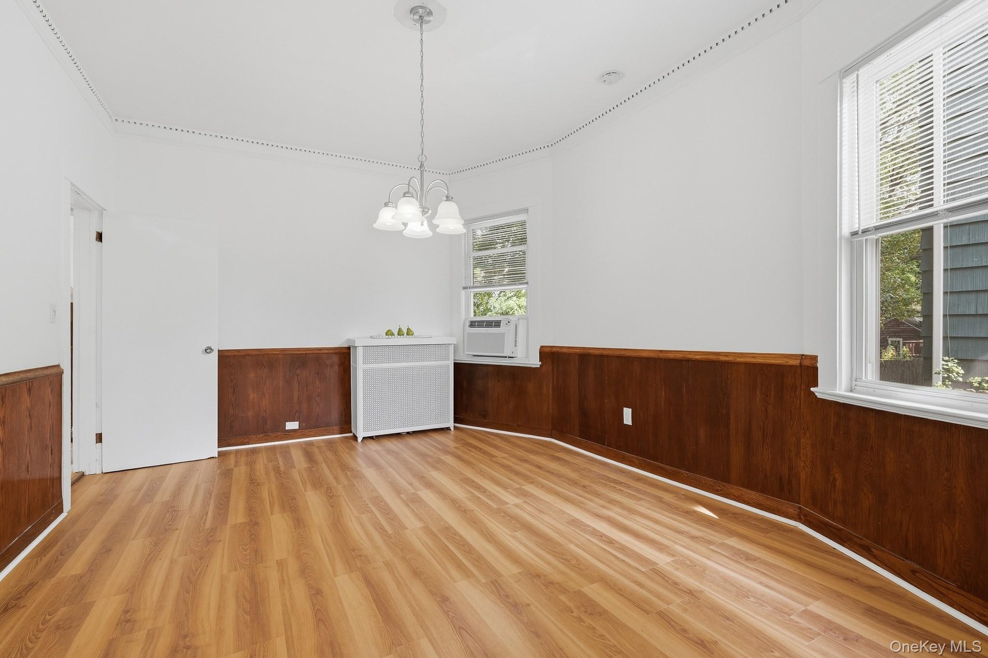 High ceilings, crown moulding, and wood wainscoting in the Dining Room