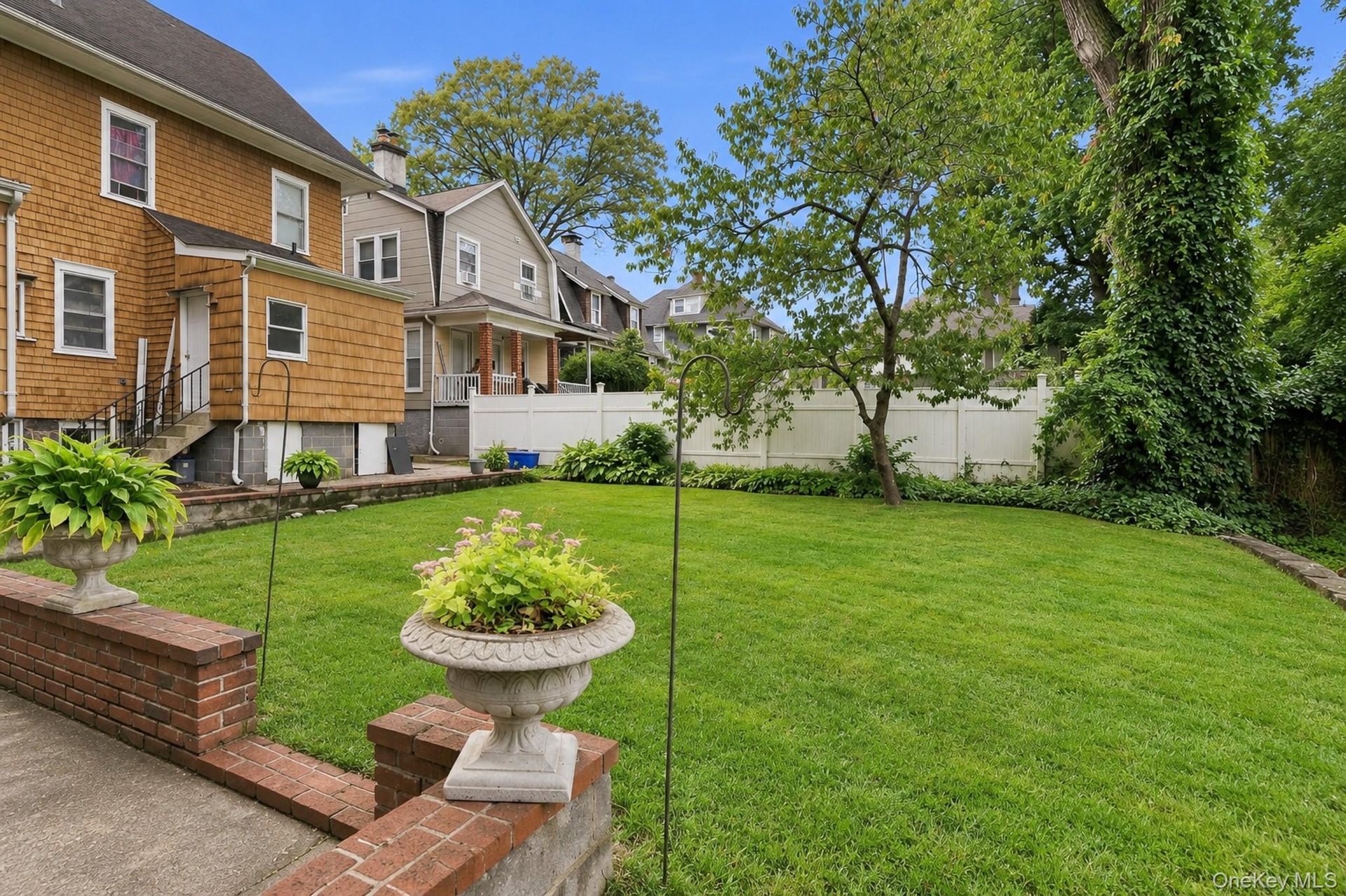 Gracious and welcoming backyard for dining, BBQing, and gardening
