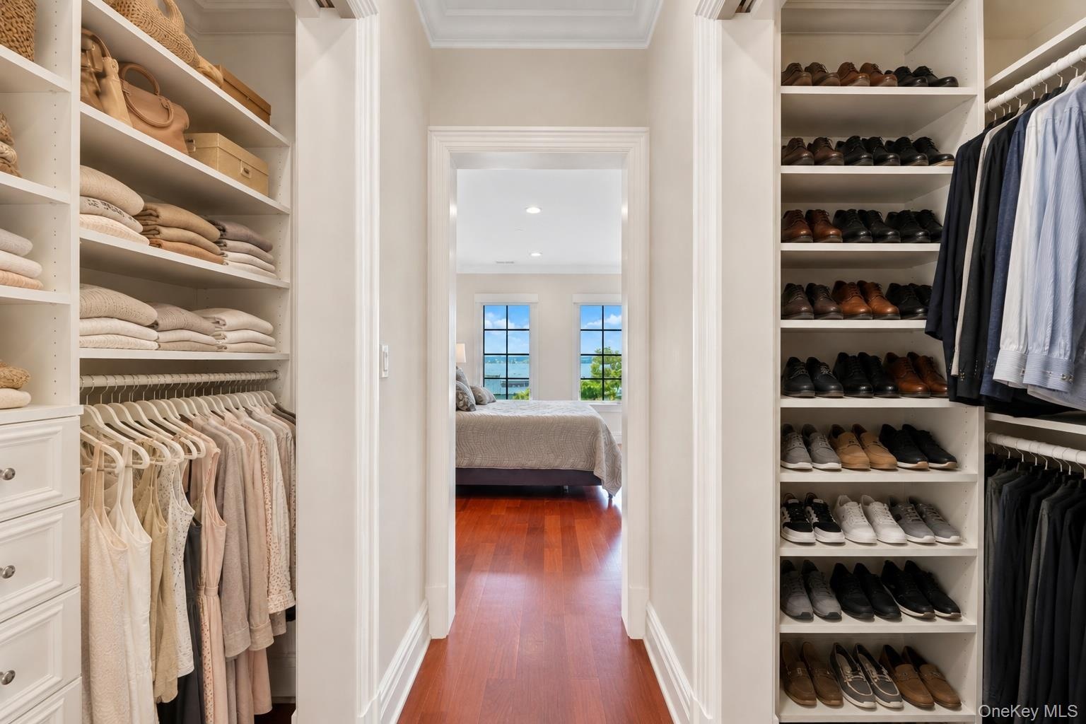 Large closets with pocket doors, custom cabinetry and shelving