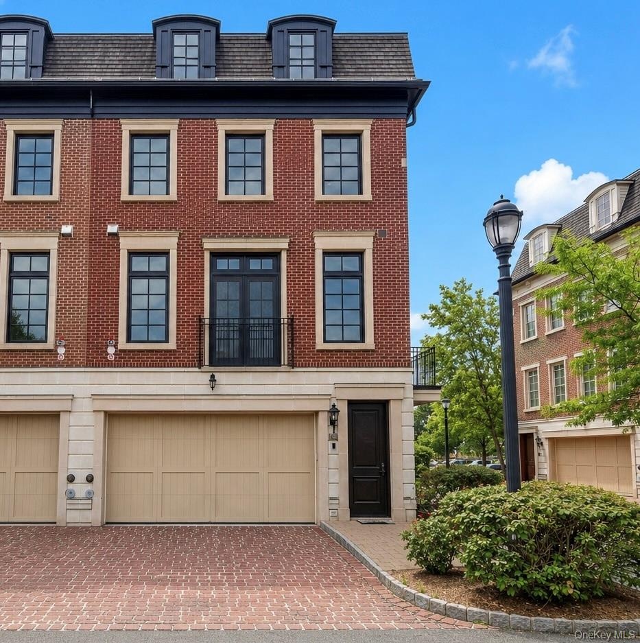 Two car garage w/ EV charging station and 2 car driveway