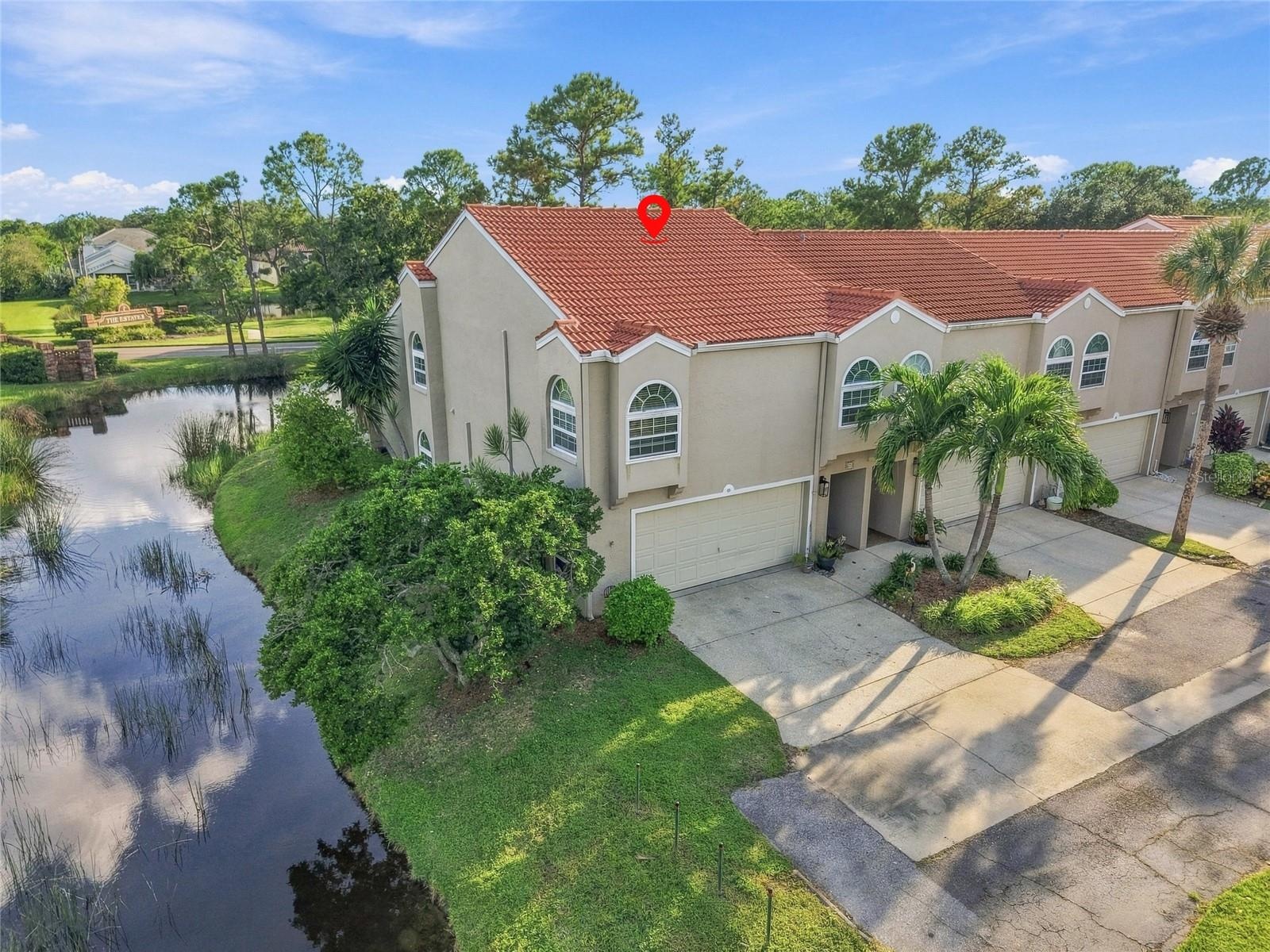 Corner unit with desirable corner setting, wraparound pond views, and generous parking.