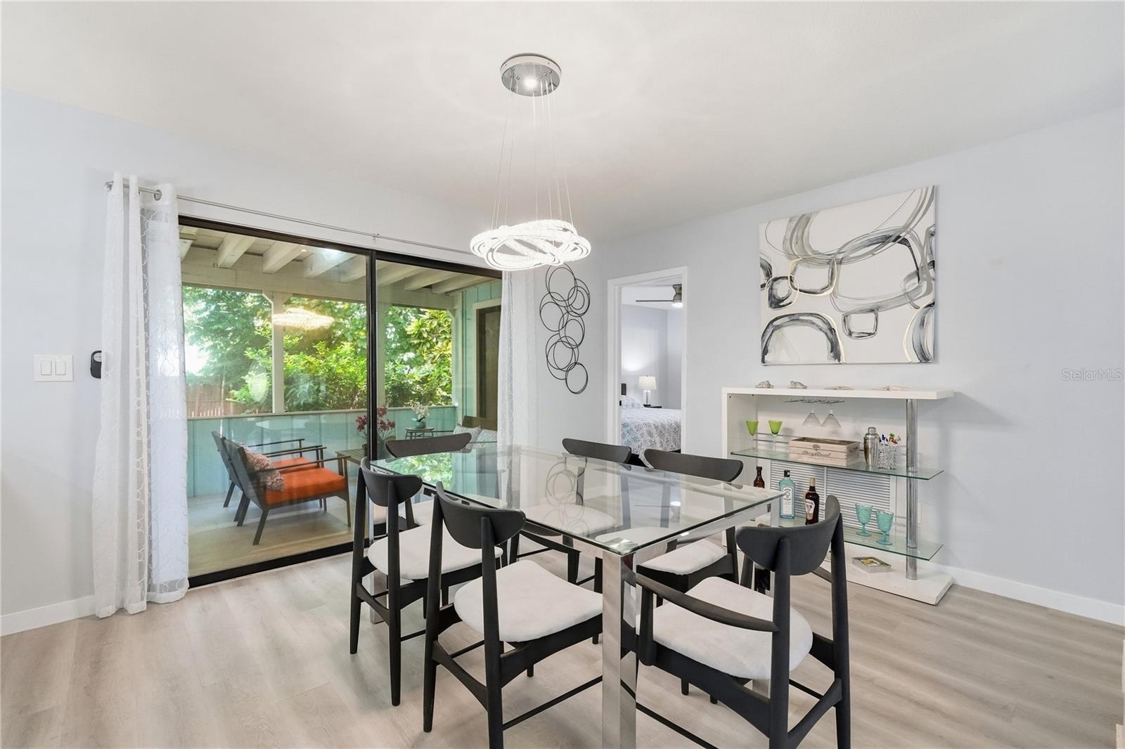 Spacious Dining Area adjacent to Large Sliders, Lanai, and Lush Landscaping.