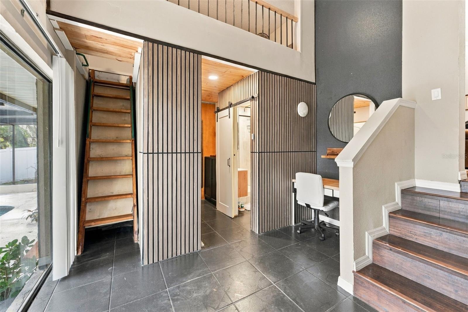 multi-purpose room with loft off main living room w/access to pool